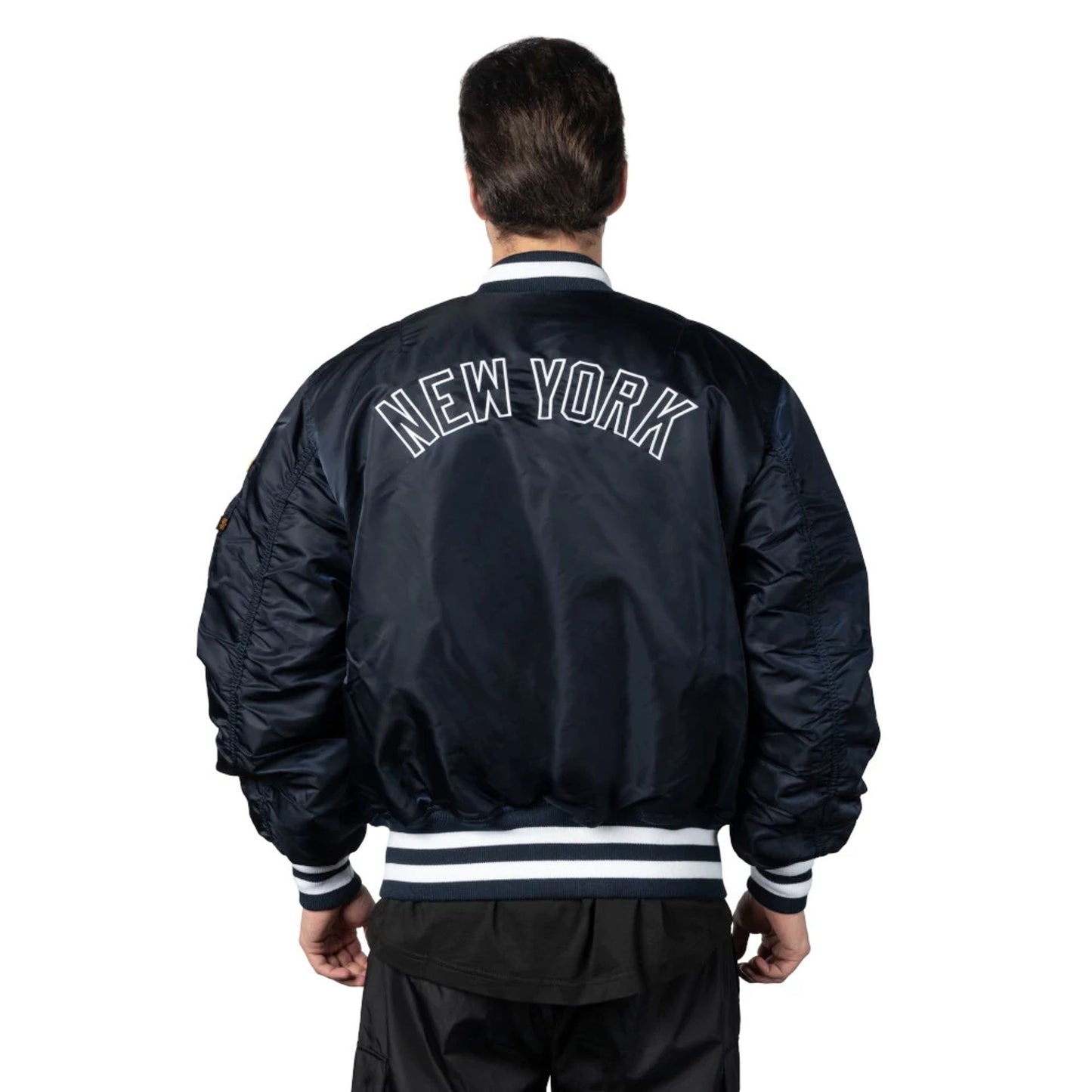 The Male model is wearing New York Yankees Alpha Industries Blue Reversible Bomber Jacket 4