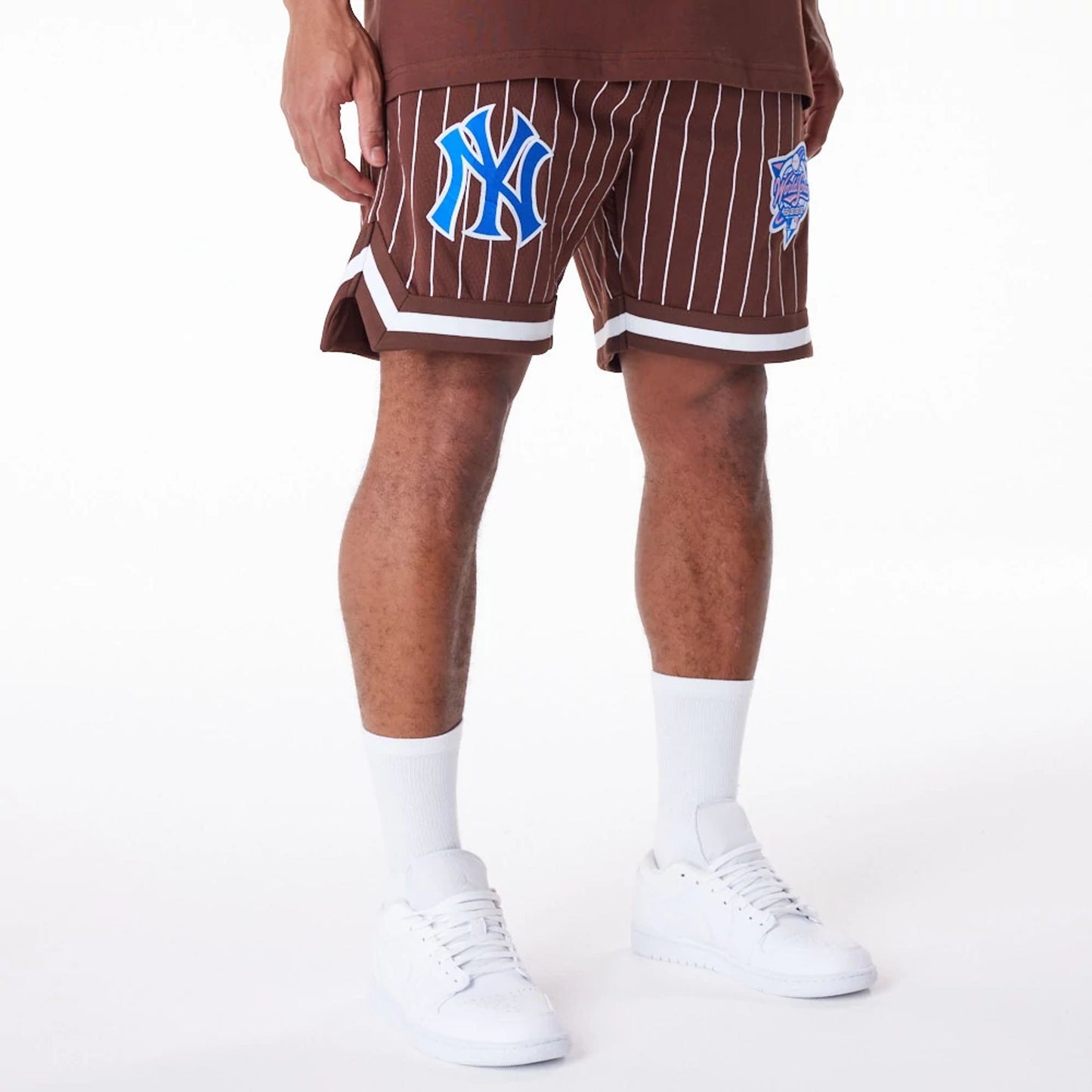 The Male model is wearing New York Yankees Pinstripe New Era Australia Brown Shorts 8