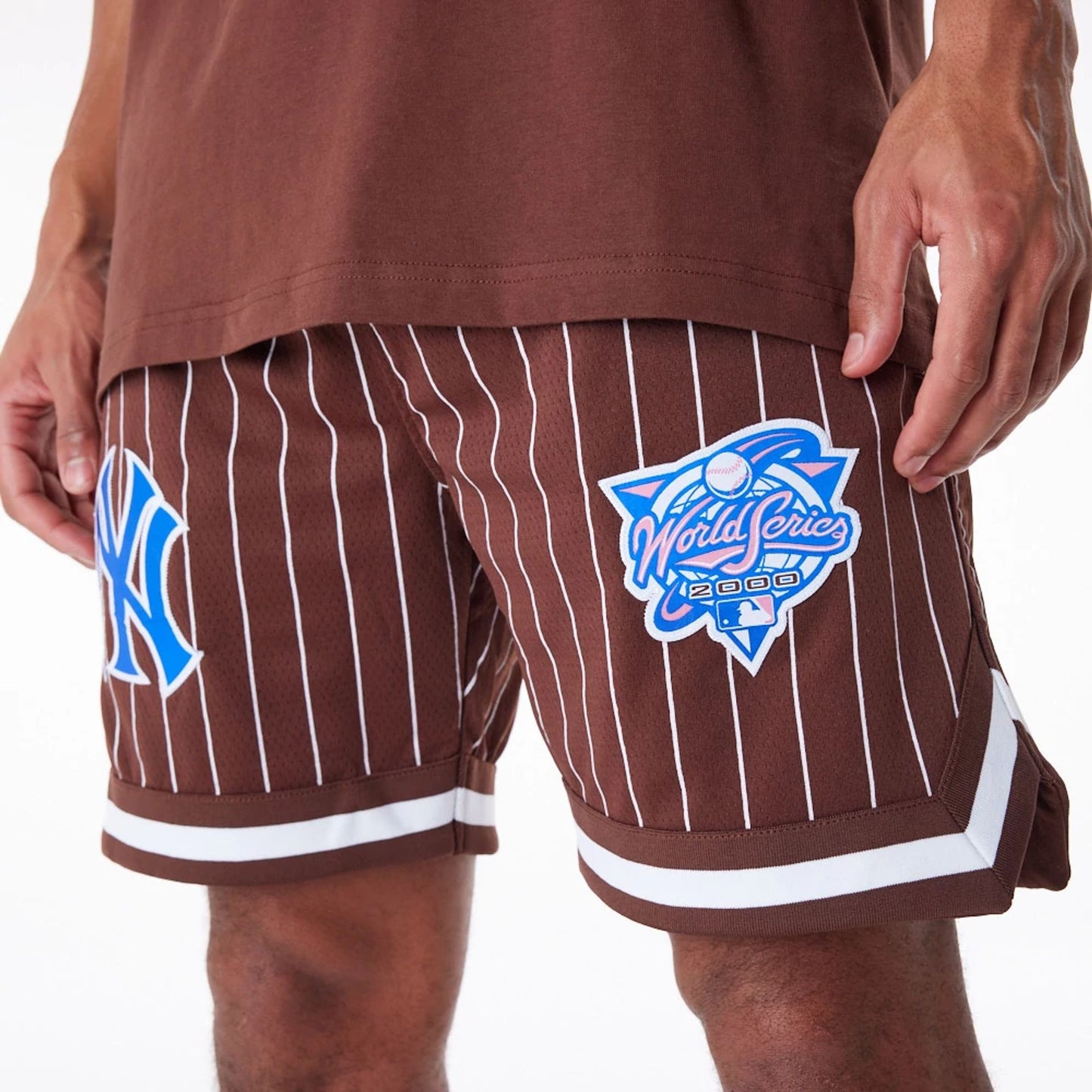 The Male model is wearing New York Yankees Pinstripe New Era Australia Brown Shorts 7