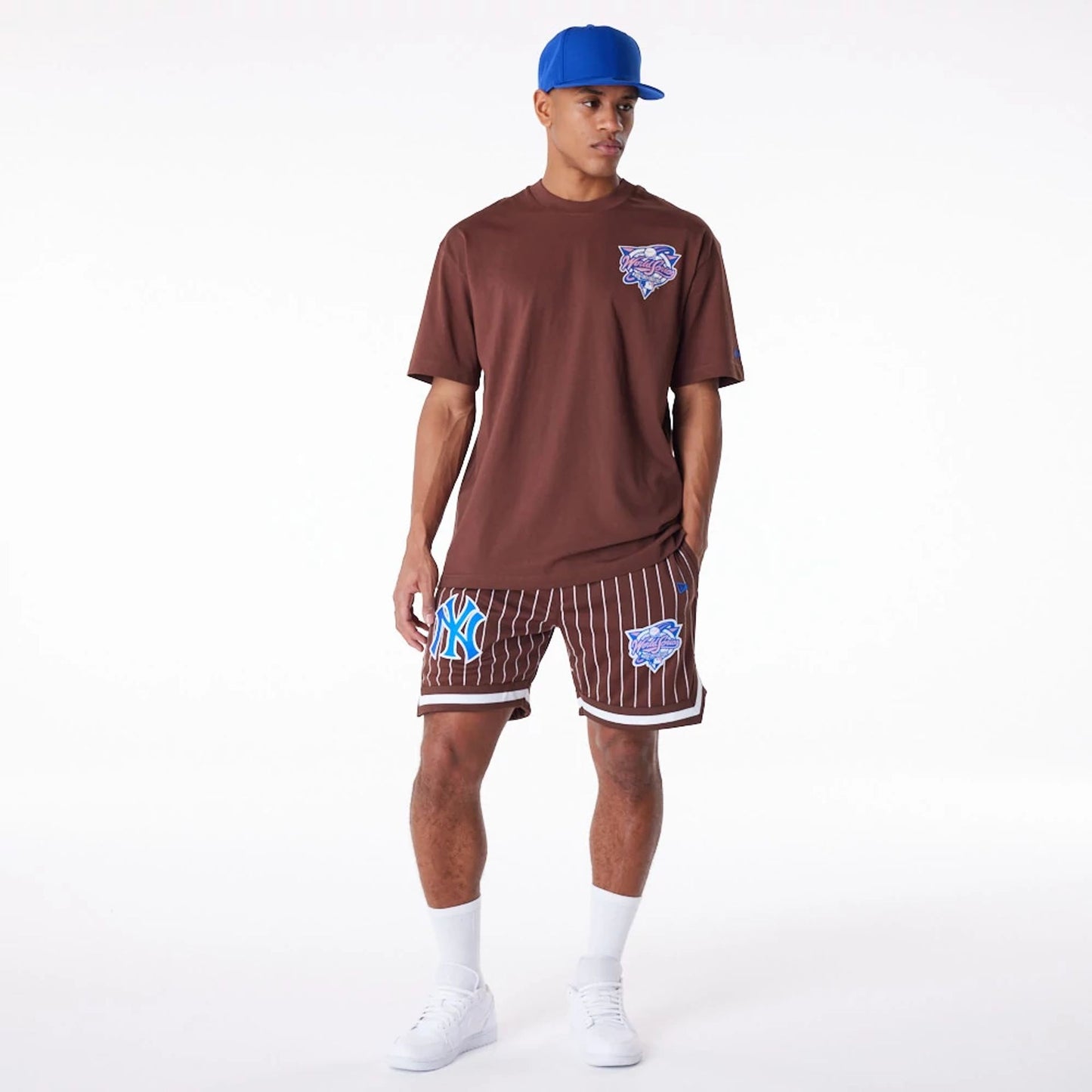 The Male model is wearing New York Yankees Pinstripe New Era Australia Brown Shorts 4