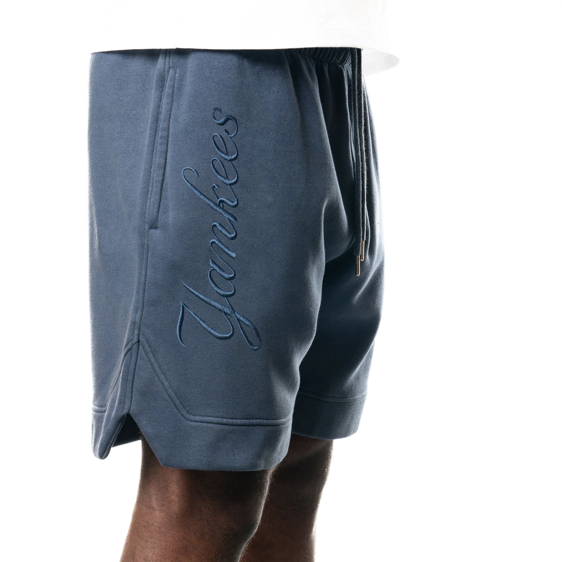 The Male model is wearing New York Yankees New Era Australia Dark Blue Fleece Shorts  3