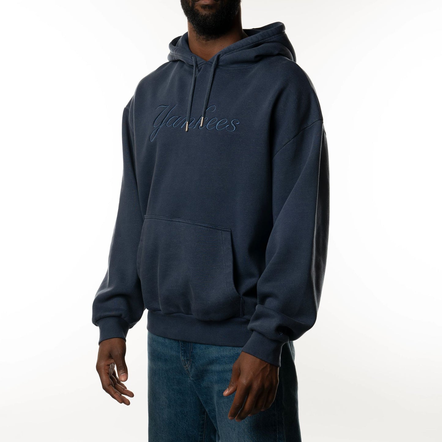 The Male model is wearing New York Yankees New Era Australia Dark Blue Oversized Pullover Hoodie  3