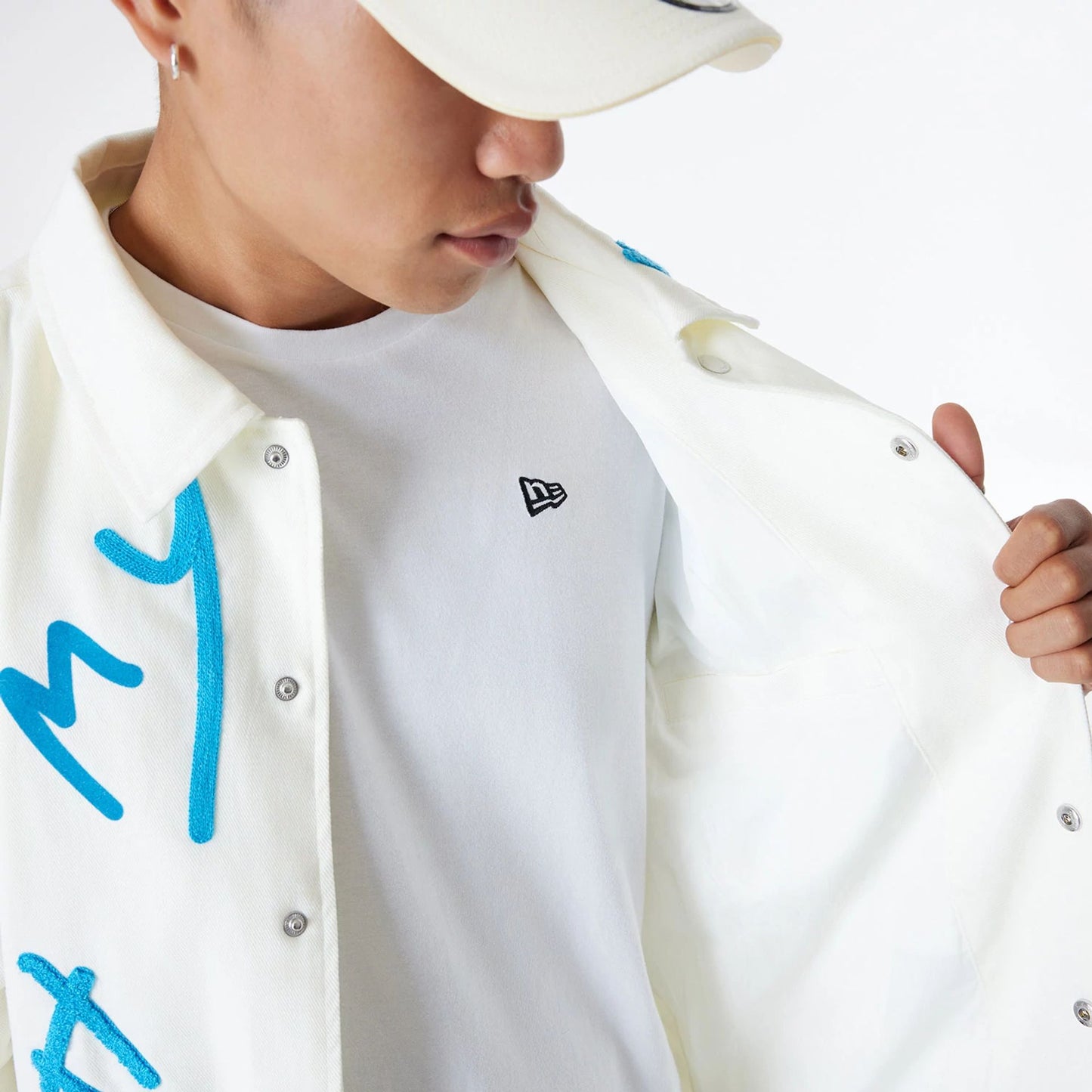 The Male model is wearing Ricardo Luévanos x New Era White Coach Jacket 5