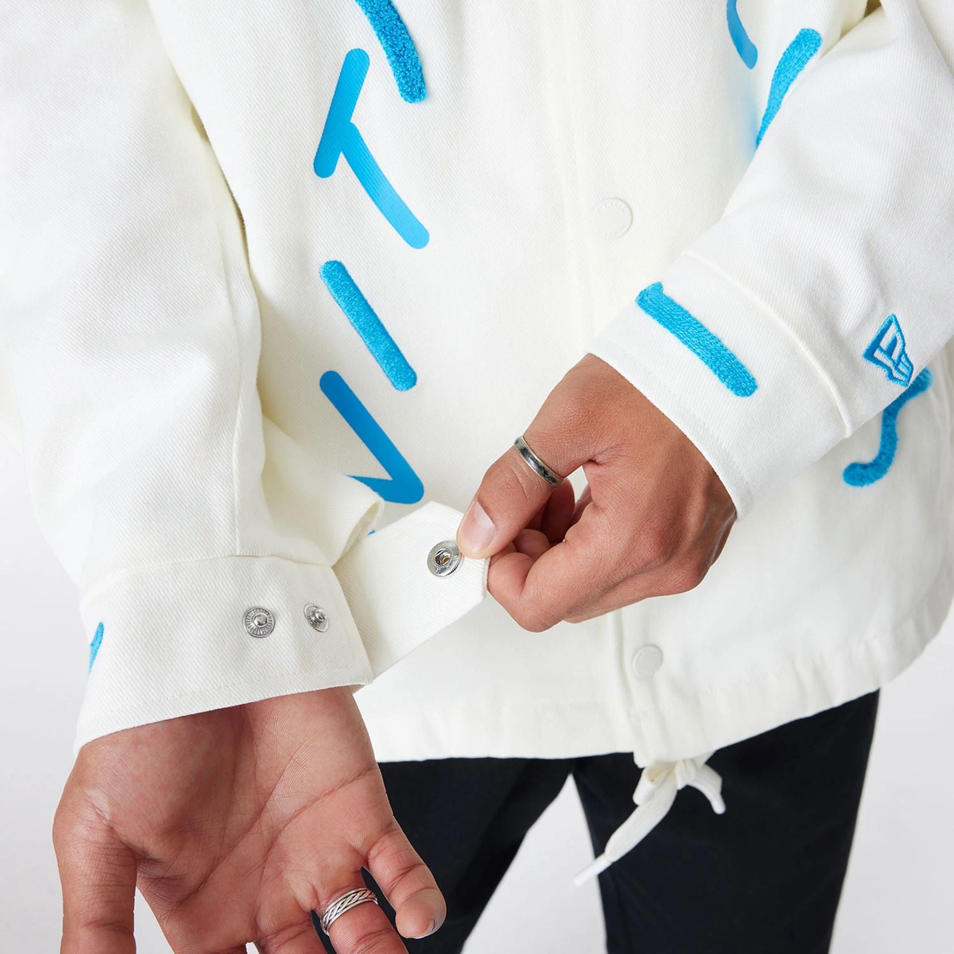 The Male model is wearing Ricardo Luévanos x New Era White Coach Jacket 6