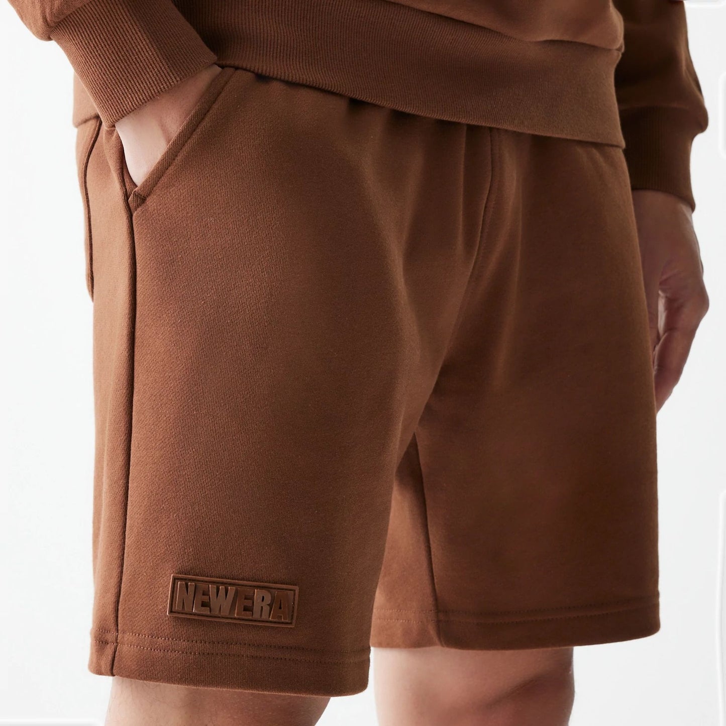 The Male model is wearing New Era Tonal Brown Shorts  4