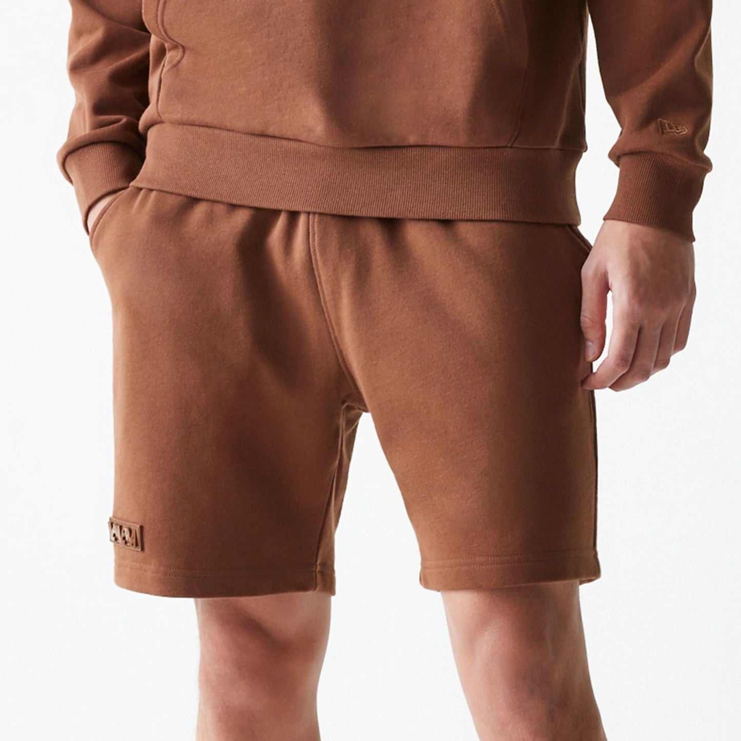 The Male model is wearing New Era Tonal Brown Shorts  3