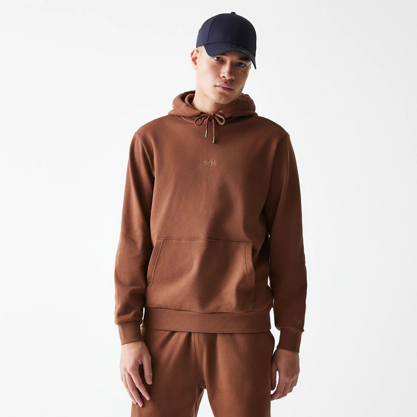 The Male model is wearing New Era Tonal Brown Pullover Hoodie  1