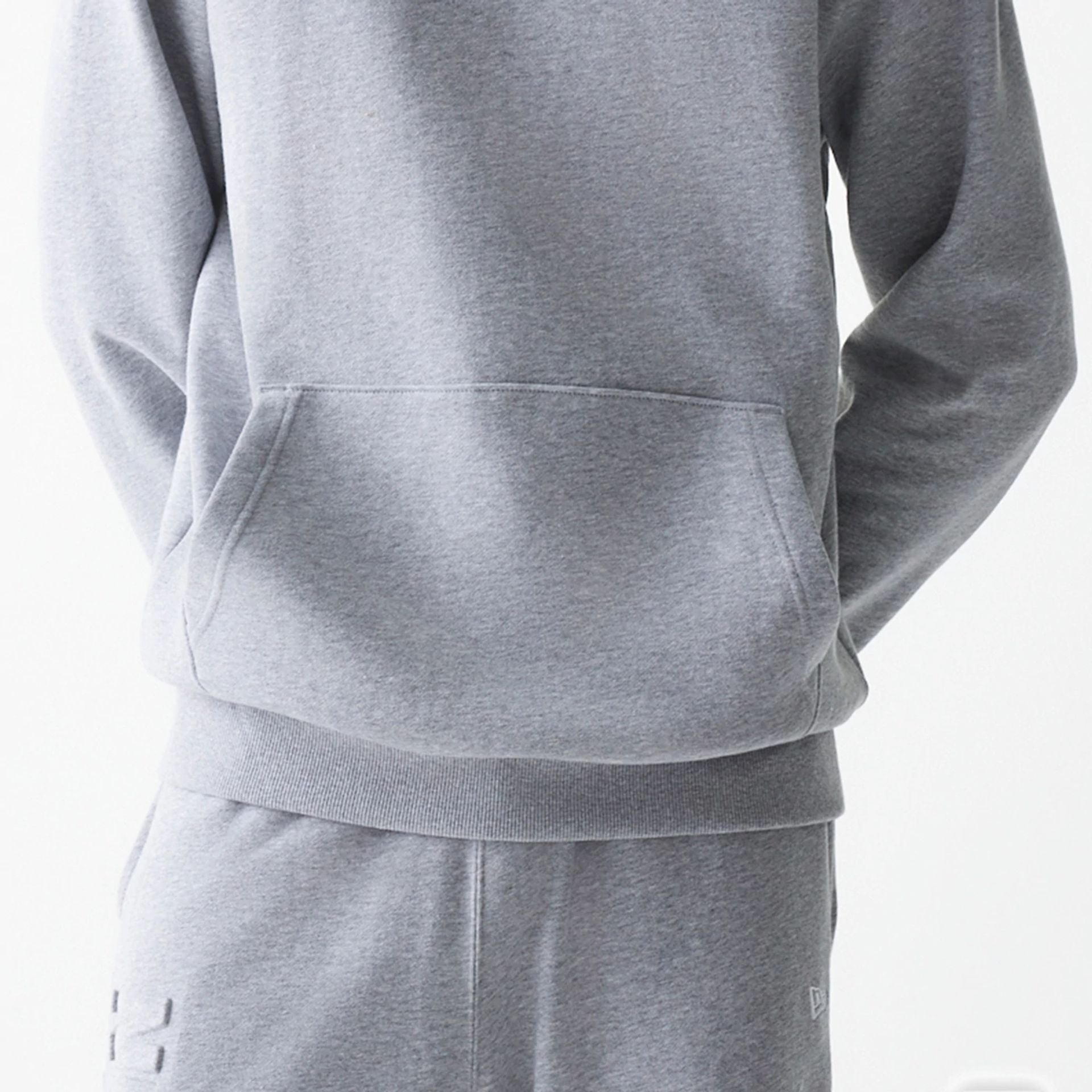 The Male model is wearing New Era Tonal Grey Pullover Hoodie  6