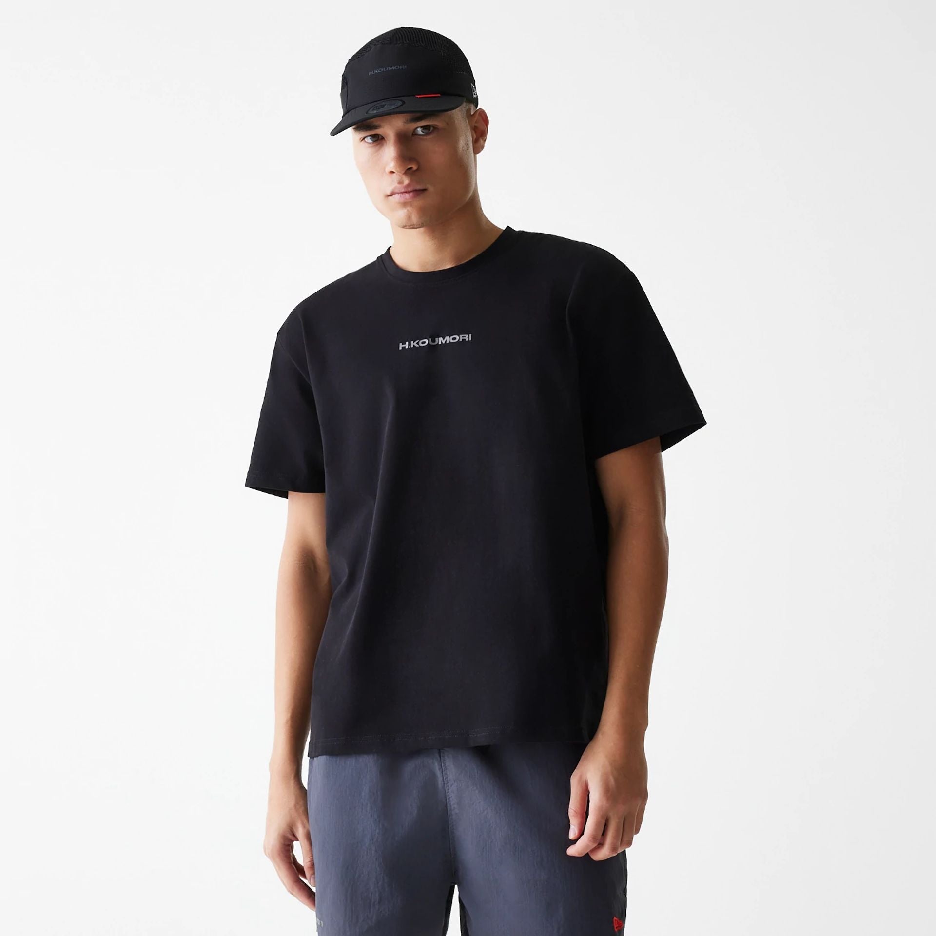 The Male model is wearing Hermanos Koumori x New Era Black T-Shirt 1