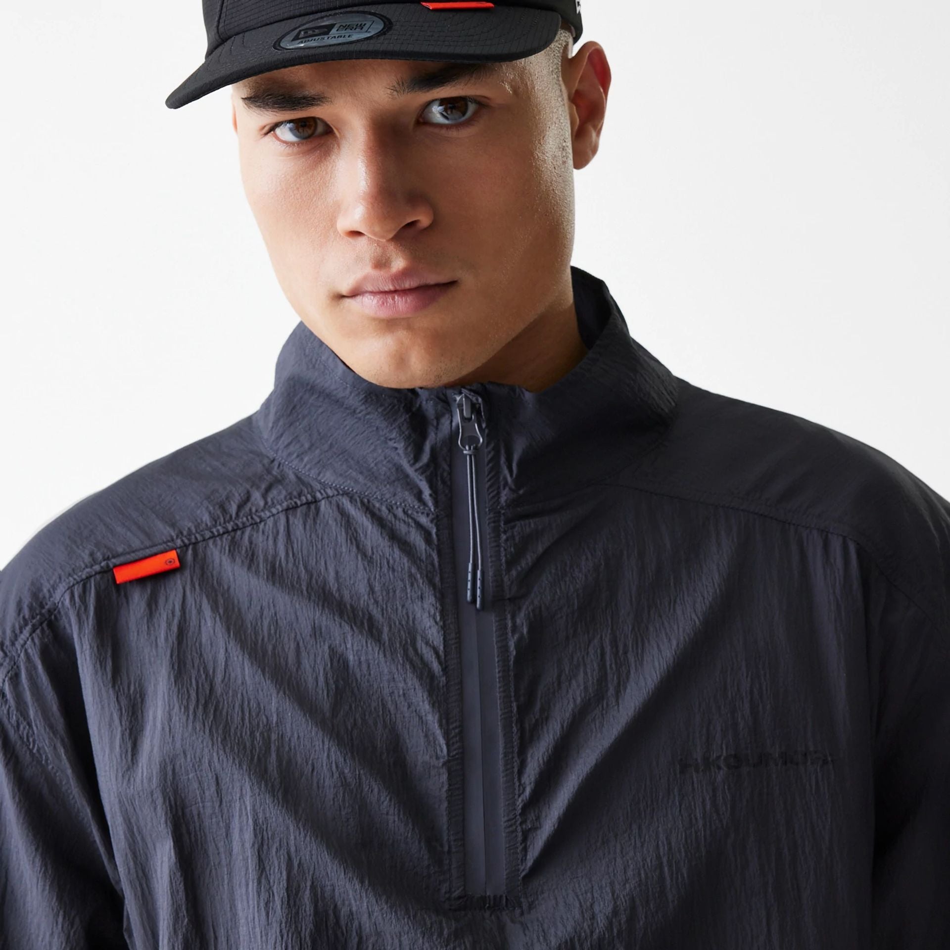 The Male model is wearing Hermanos Koumori x New Era Dark Grey Track Jacket 3