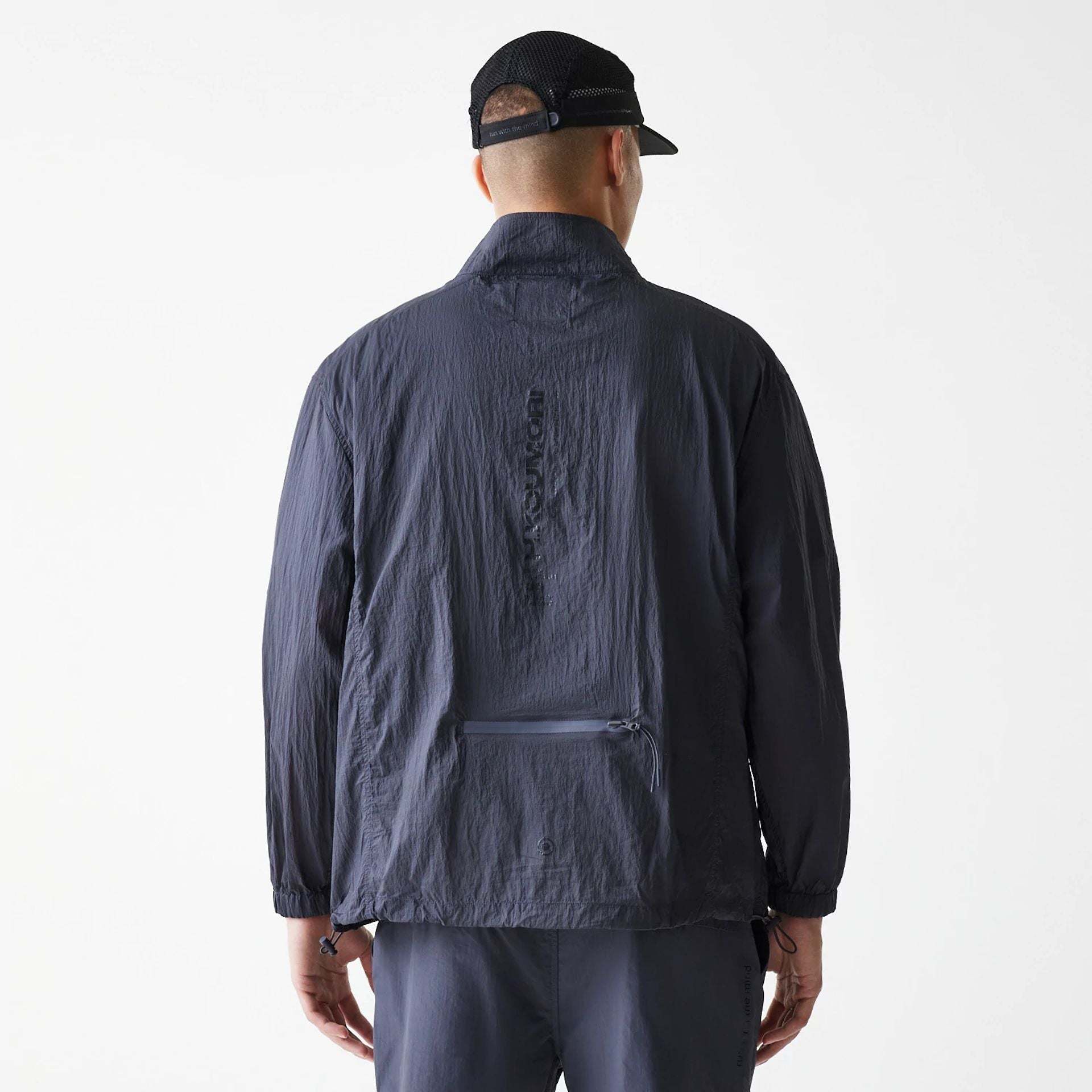 The Male model is wearing Hermanos Koumori x New Era Dark Grey Track Jacket 2