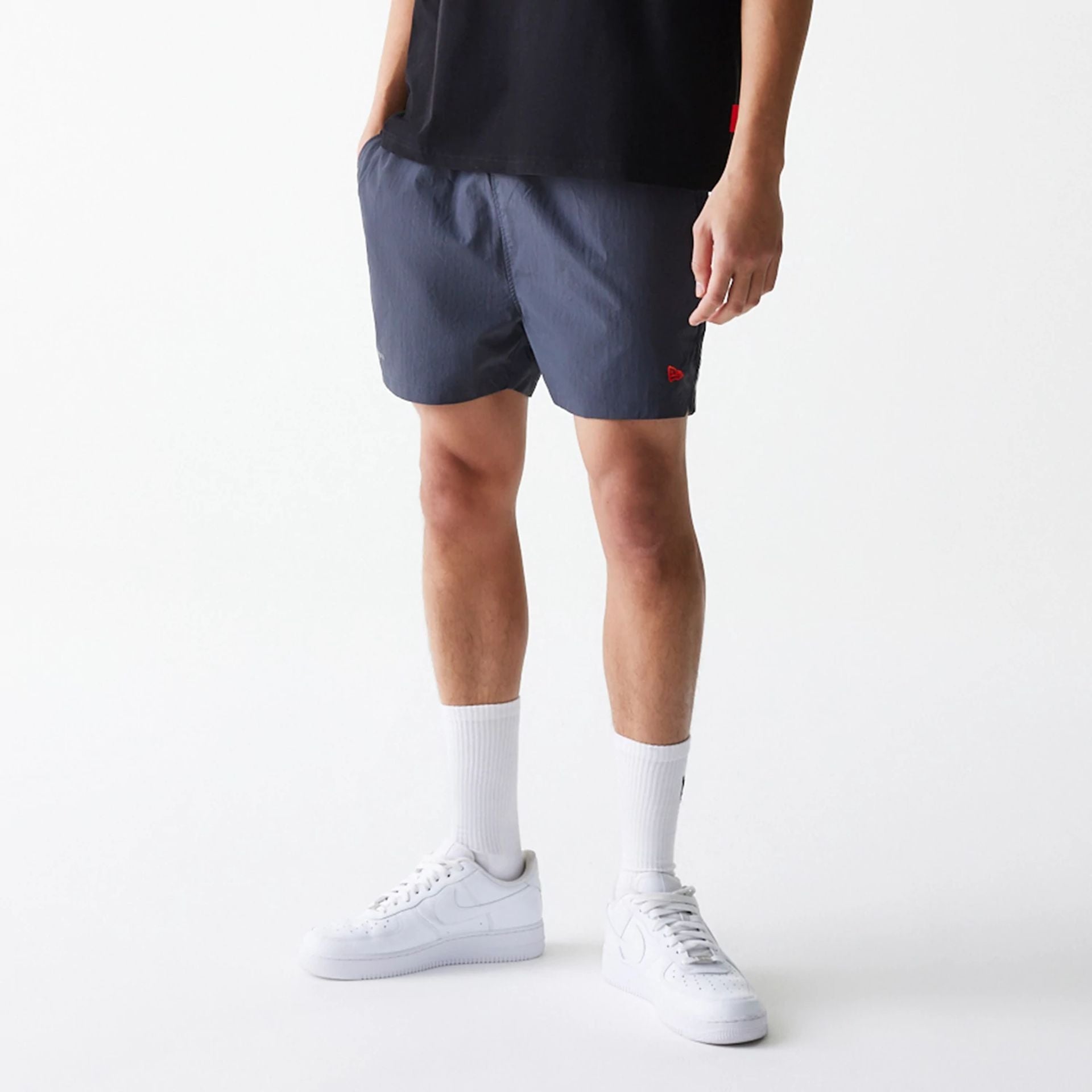 The Male model is wearing Hermanos Koumori x New Era Dark Grey Shorts 1