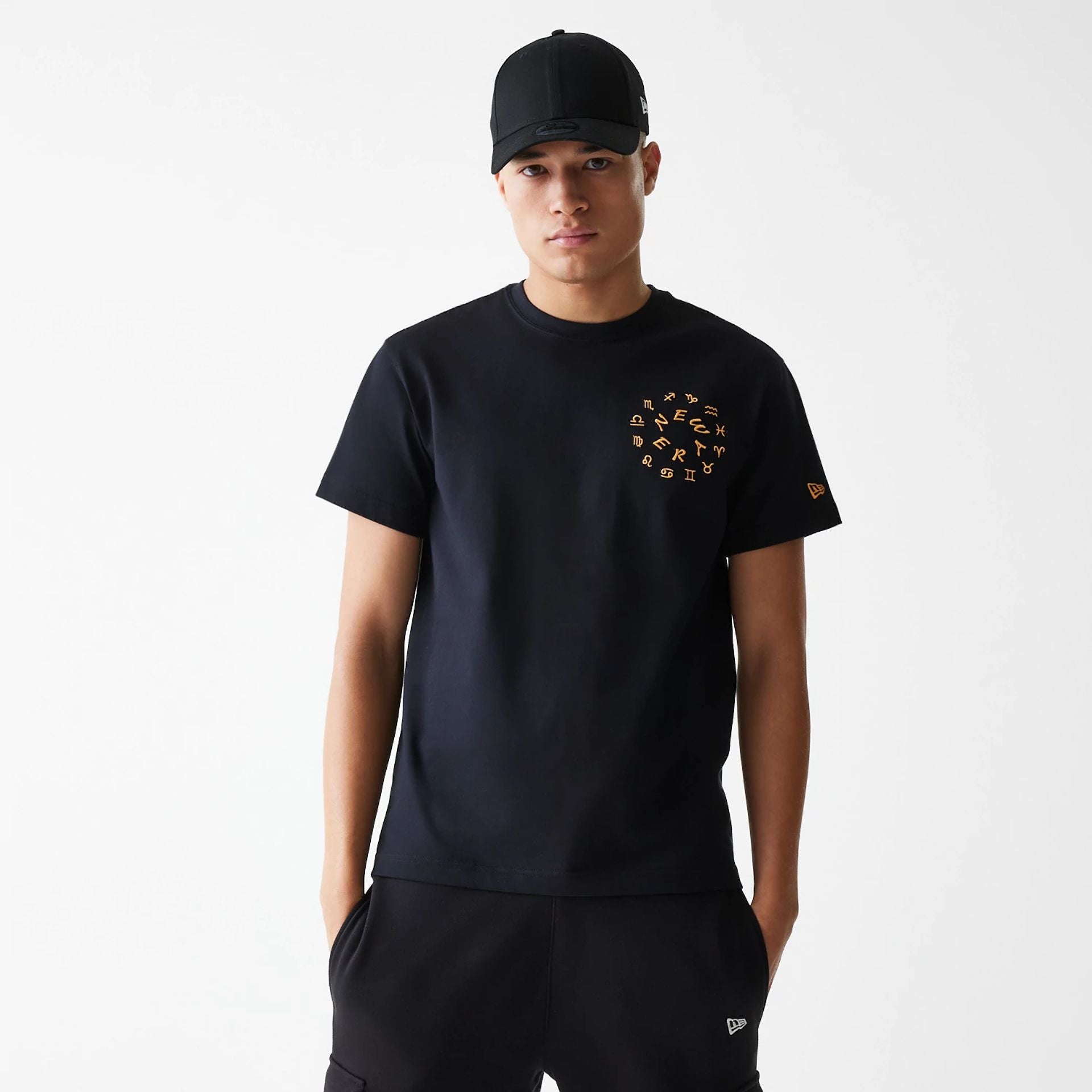 The Male model is wearing New Era Horoscope Black T-Shirt 1