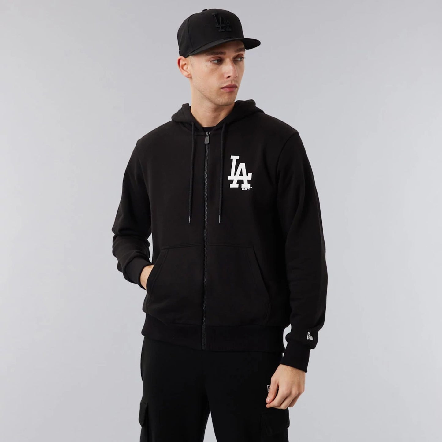 The Male model is wearing LA Dodgers MLB League Essential Black Full-Zip Hoodie 1