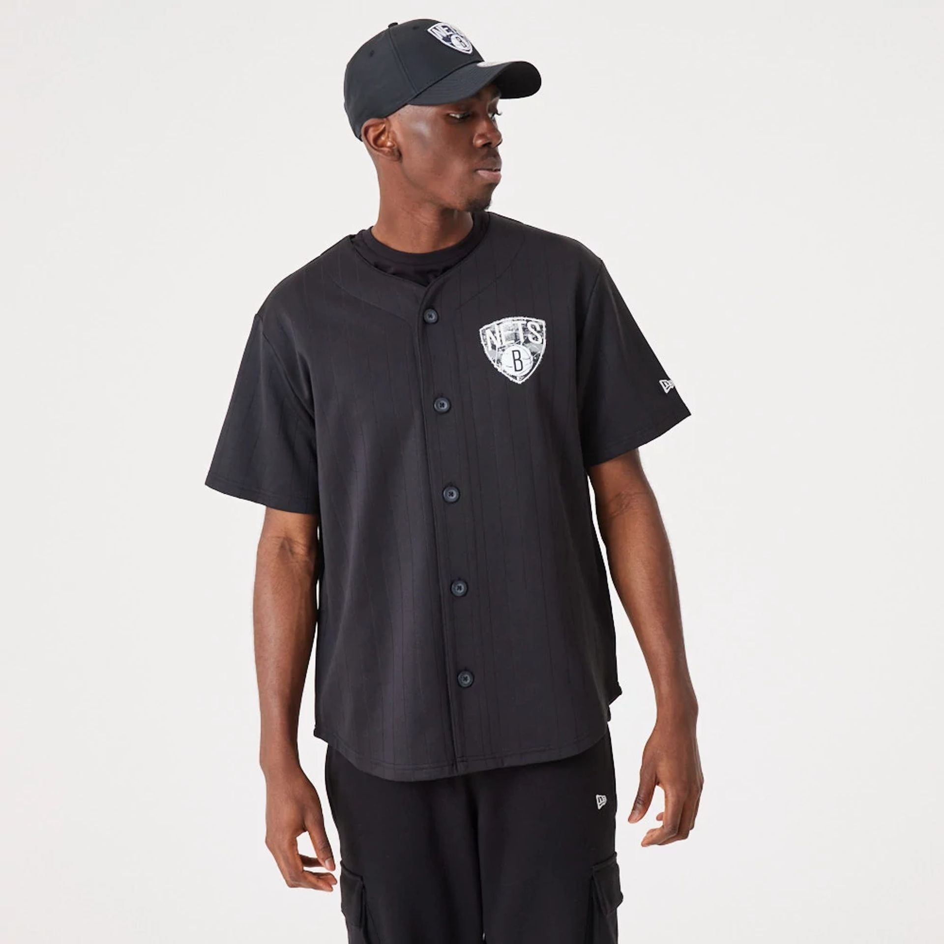 The Male model is wearing Brooklyn Nets NBA Infill Team Logo Black Jersey 2