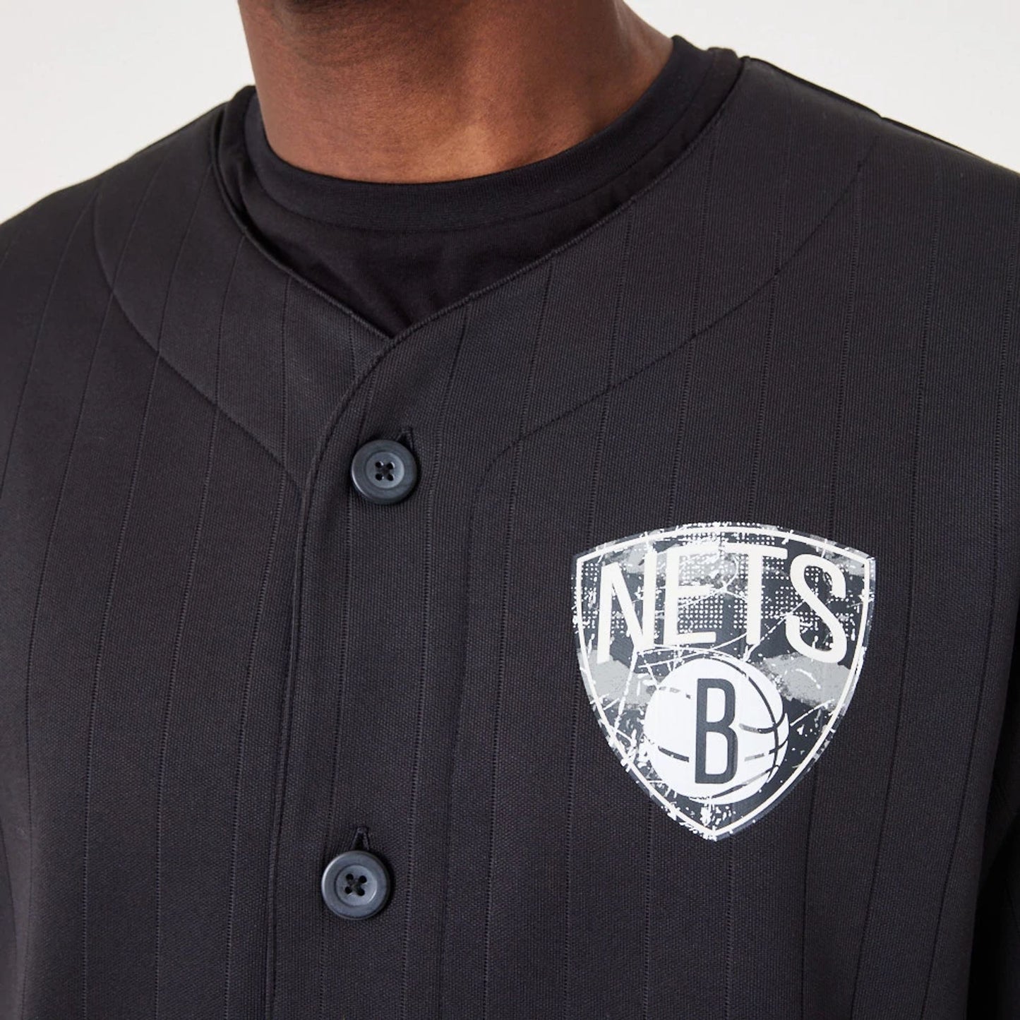 The Male model is wearing Brooklyn Nets NBA Infill Team Logo Black Jersey 5