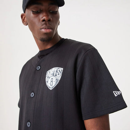 The Male model is wearing Brooklyn Nets NBA Infill Team Logo Black Jersey 7