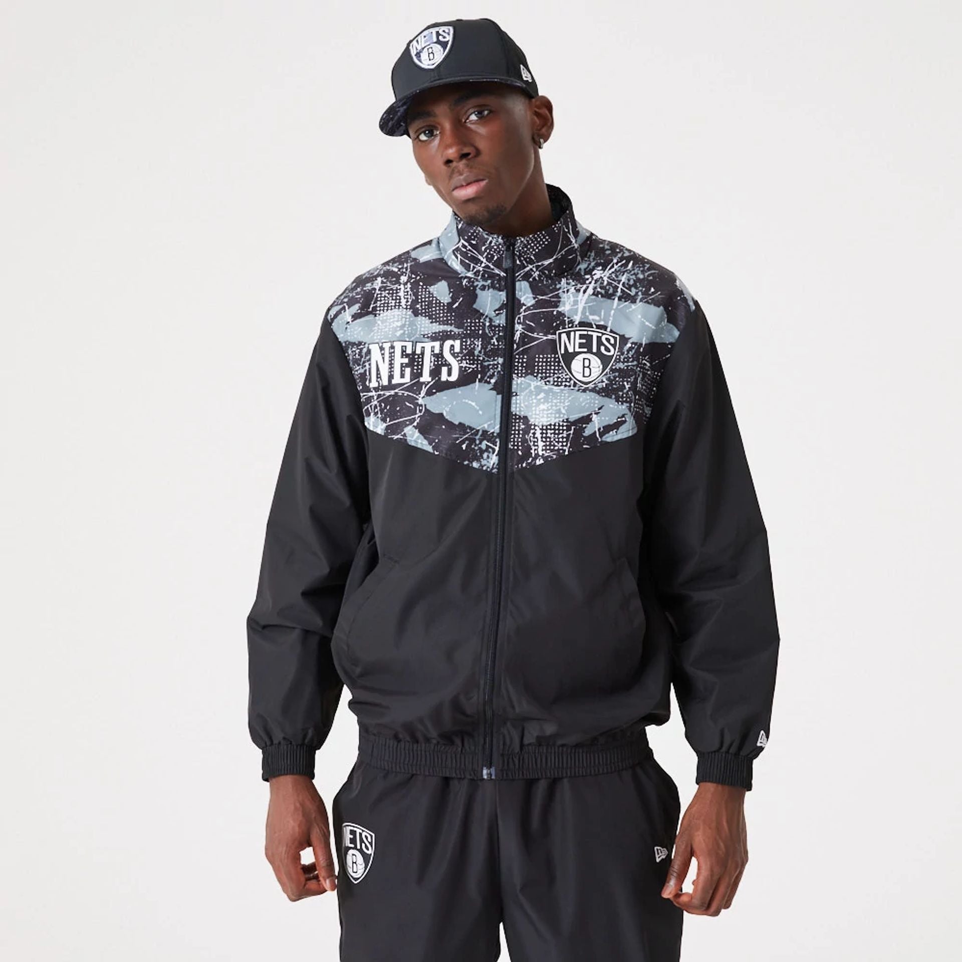 The Male model is wearing Brooklyn Nets NBA All Over Print Black Track Jacket 1