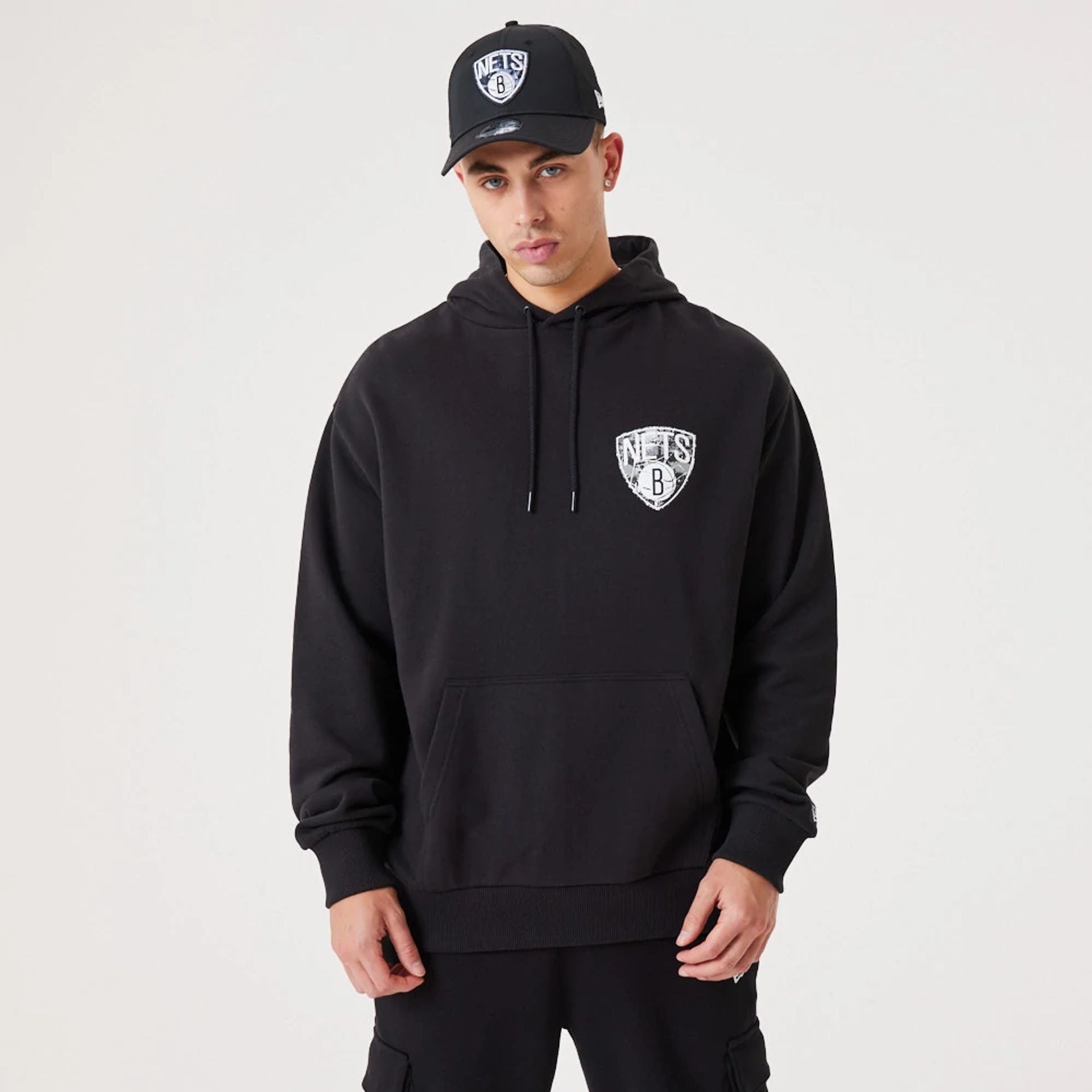 The Male model is wearing Brooklyn Nets NBA Infill Team Logo Black Pullover Hoodie 2