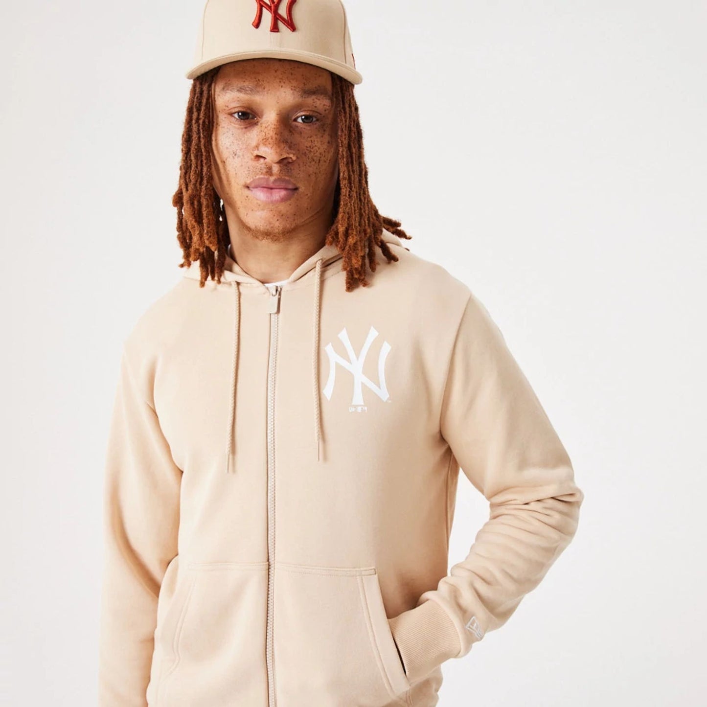 The Male model is wearing New York Yankees MLB League Essential Light Beige Full-Zip Hoodie 6