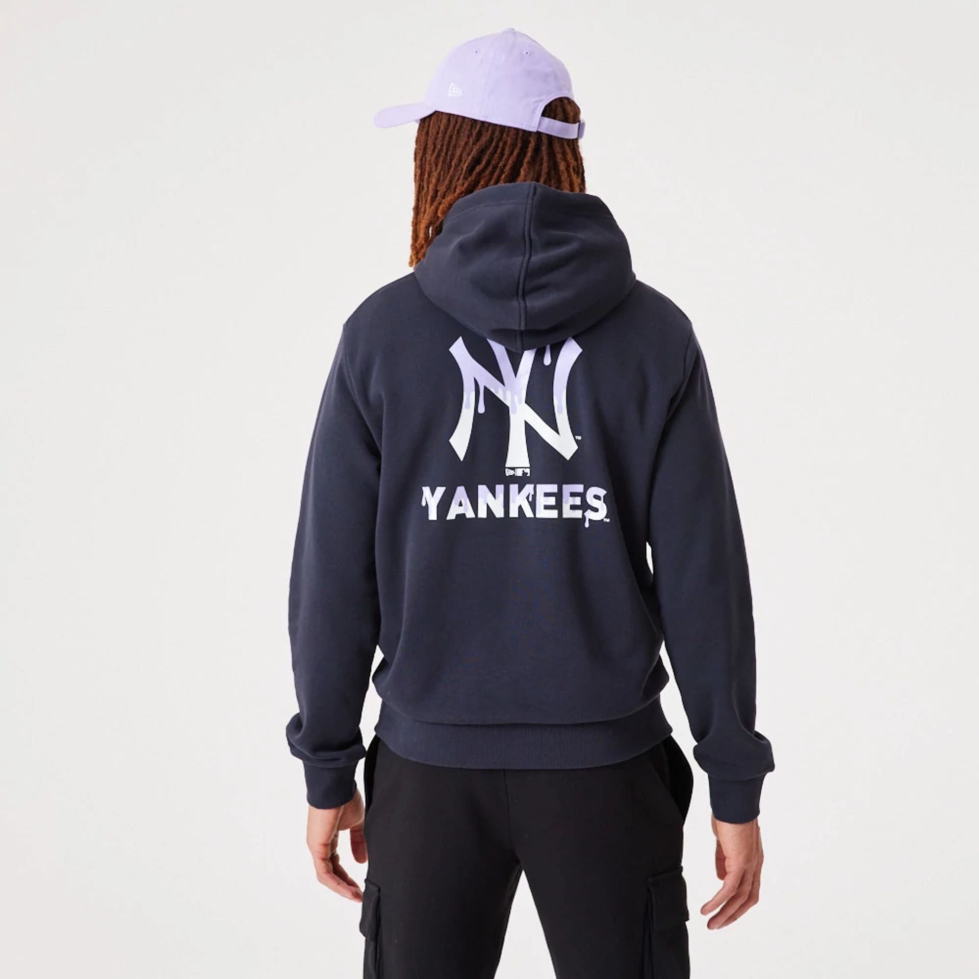 The Male model is wearing New York Yankees MLB Drip Logo Navy Pullover Hoodie 1