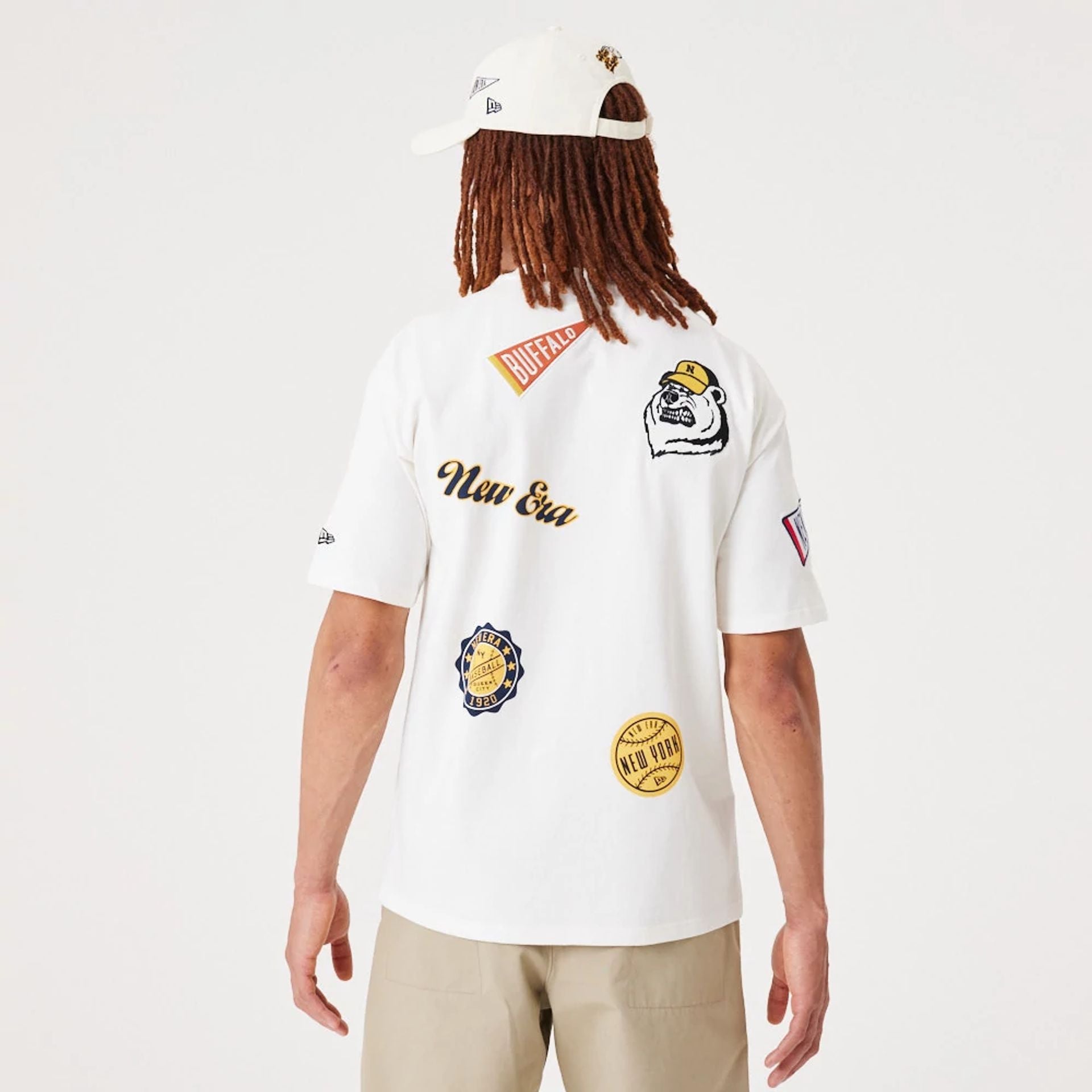 The Male model is wearing New Era Heritage Badge Open White Oversized T-Shirt 2