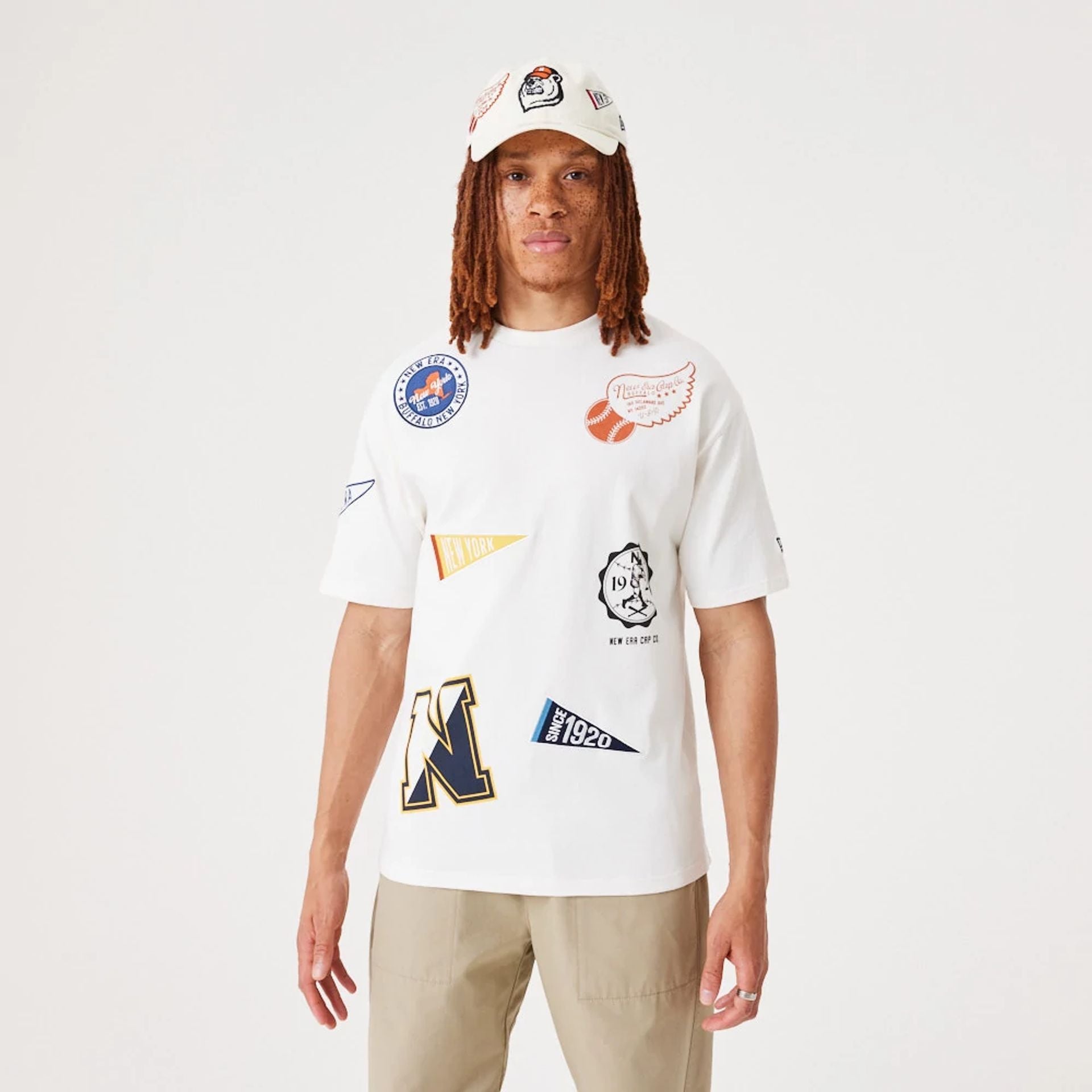 The Male model is wearing New Era Heritage Badge Open White Oversized T-Shirt 1