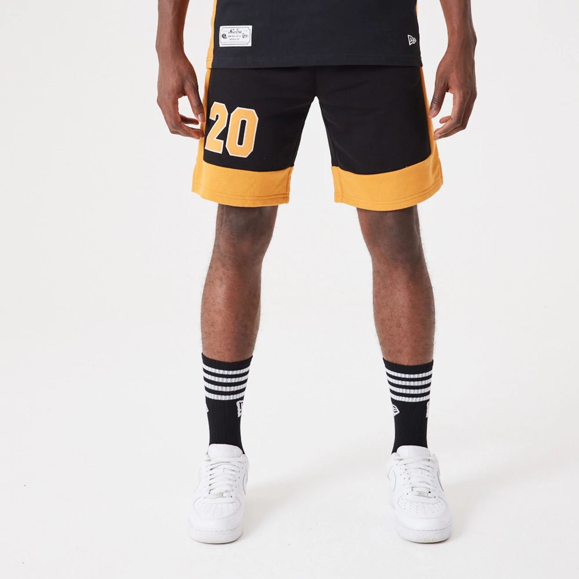 The Male model is wearing New Era Contemporary Black Oversized Shorts 1