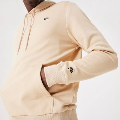 The Male model is wearing New Era Essential Light Beige Pullover Hoodie 4