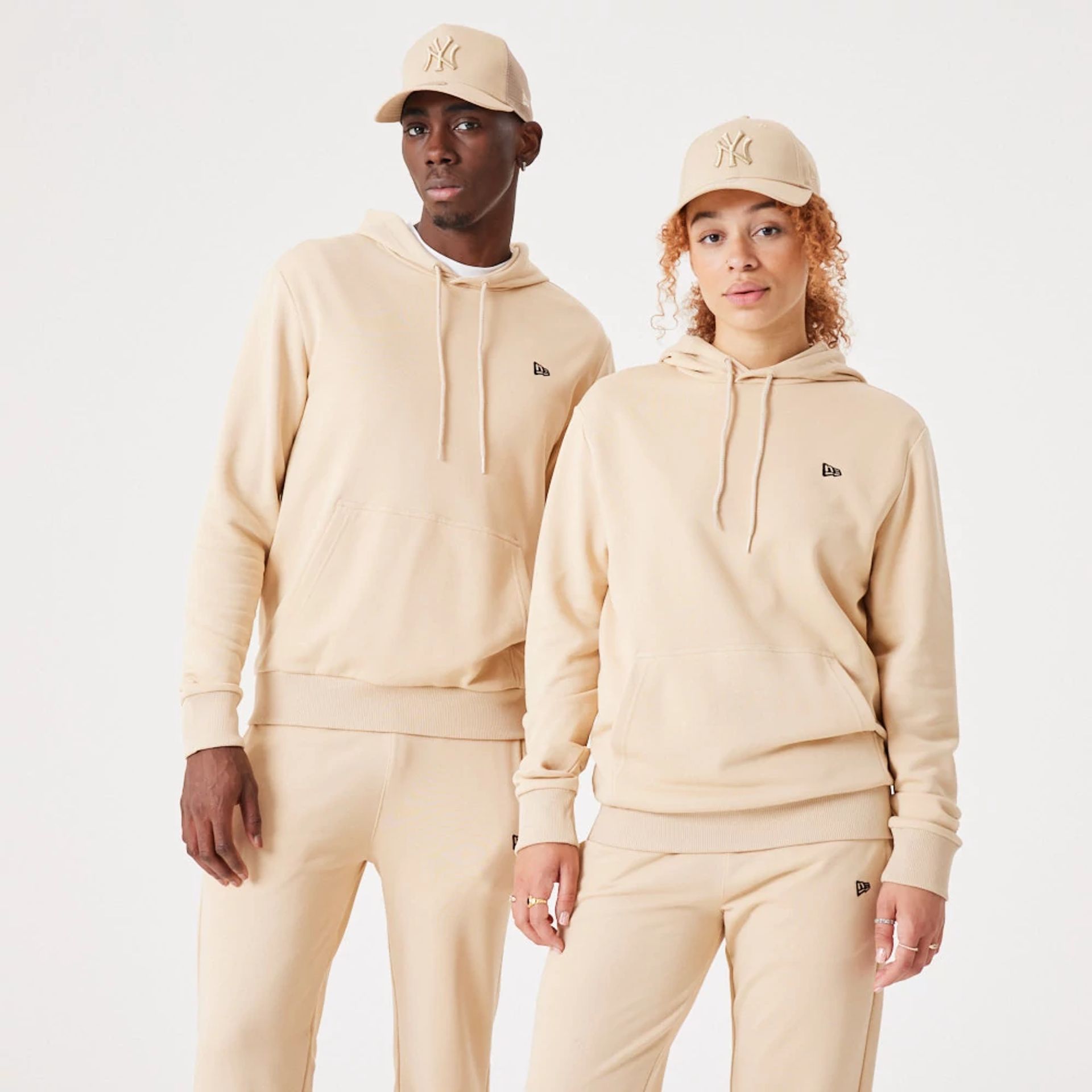 The Male model is wearing New Era Essential Light Beige Pullover Hoodie 1