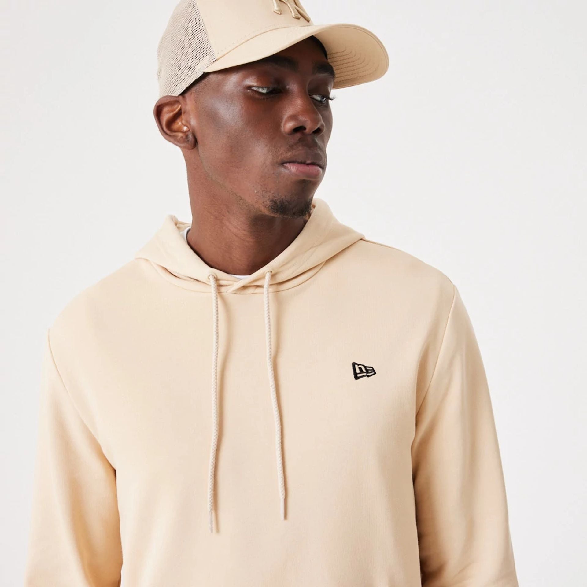 The Male model is wearing New Era Essential Light Beige Pullover Hoodie 6