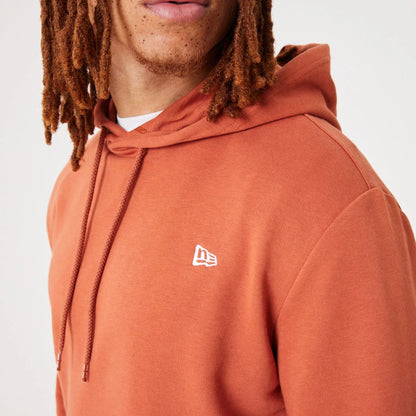 The Male model is wearing New Era Essential Medium Brown Pullover Hoodie 4