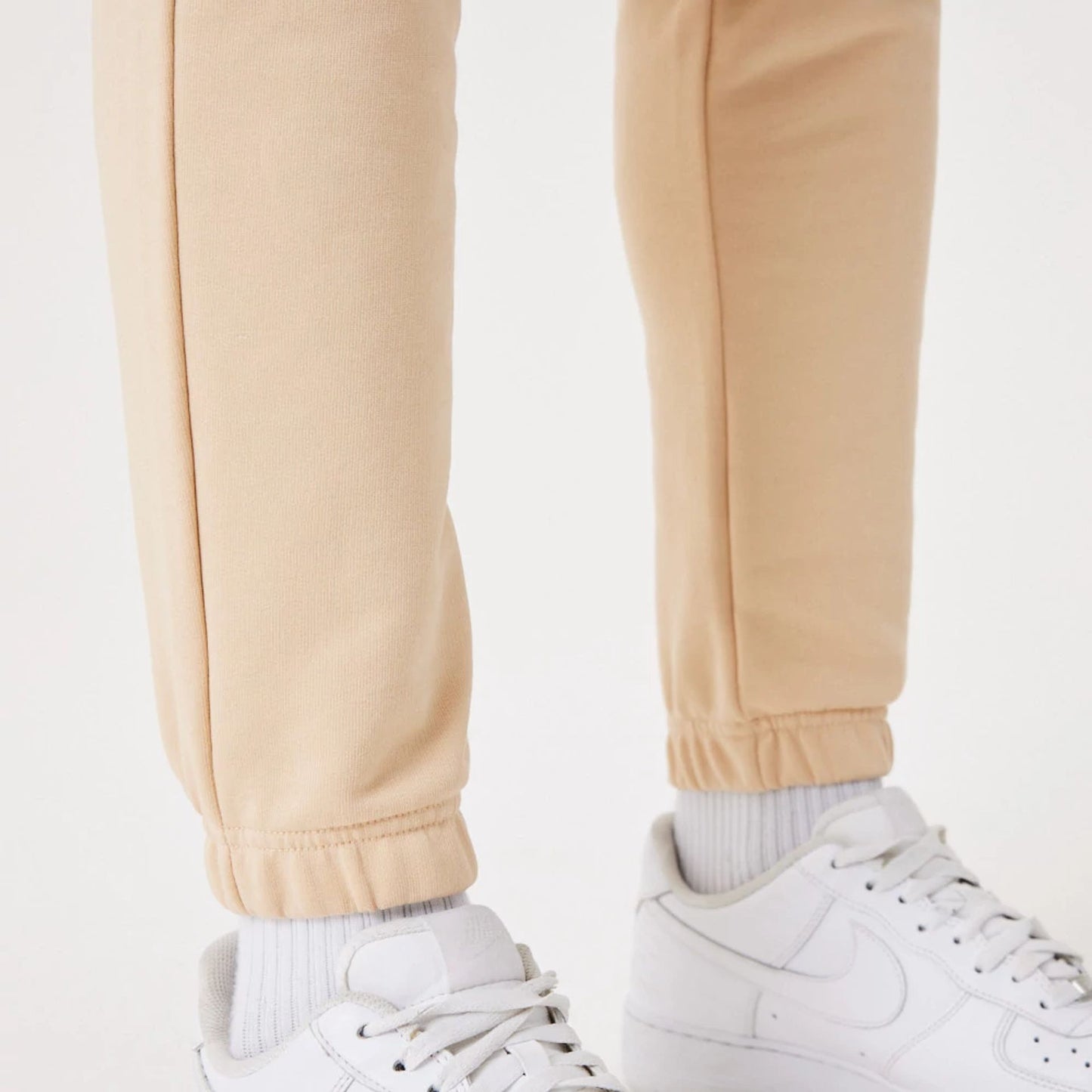 The Male model is wearing New Era Essential Light Beige Joggers 5