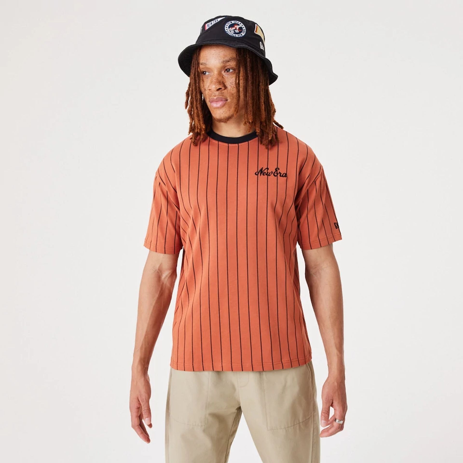 The Male model is wearing New Era Pinstripe Medium Brown Oversized T-Shirt 1