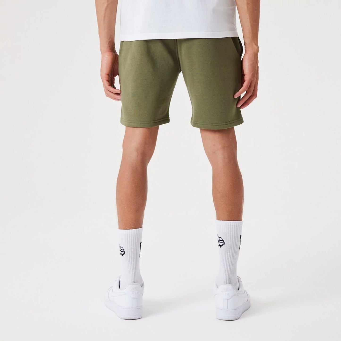 The Male model is wearing New York Yankees MLB League Essential Medium Green Shorts 2