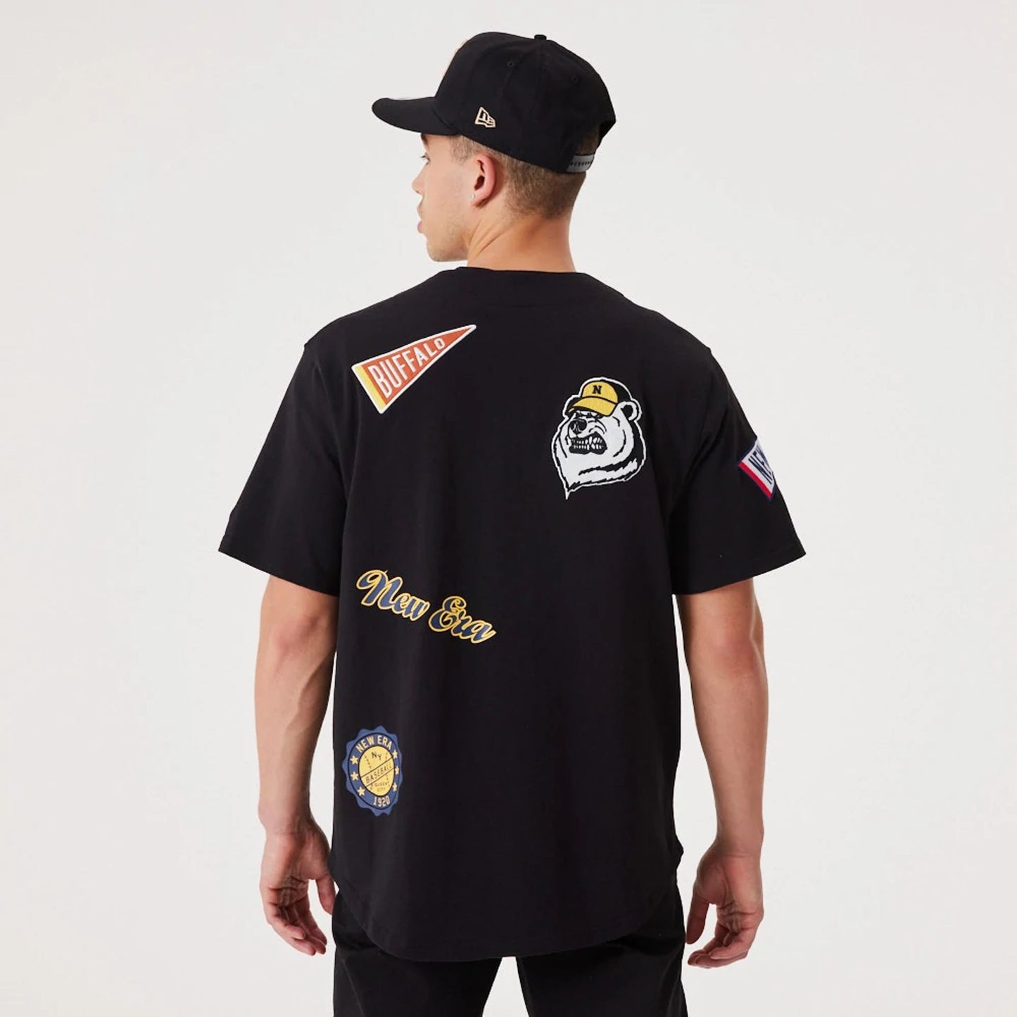 The Male model is wearing New Era Heritage Badge Black Jersey 2