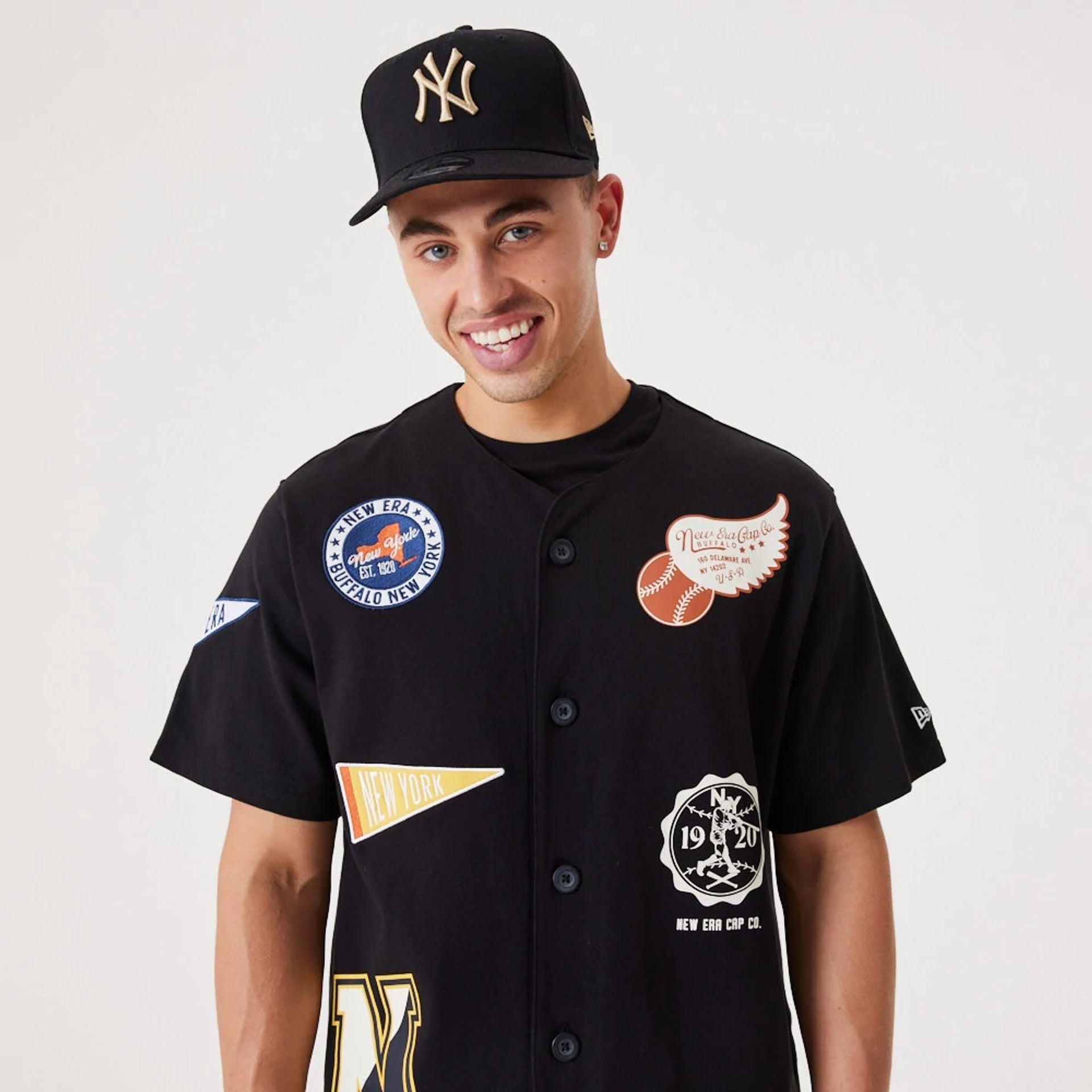 The Male model is wearing New Era Heritage Badge Black Jersey 3