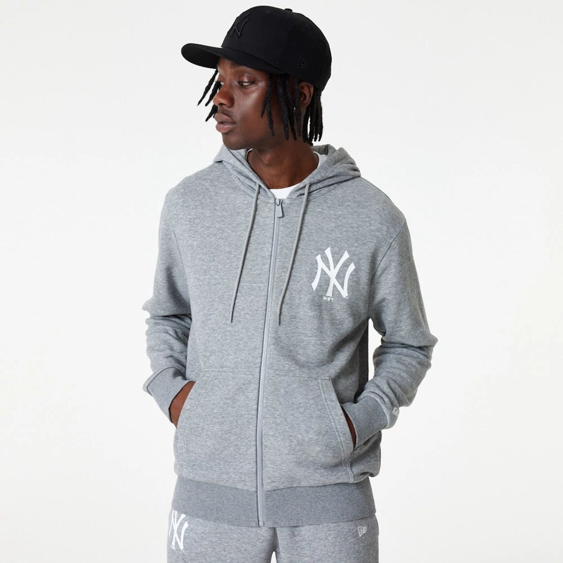 The Male model is wearing New York Yankees MLB League Essential Medium Grey Full-Zip Hoodie 1