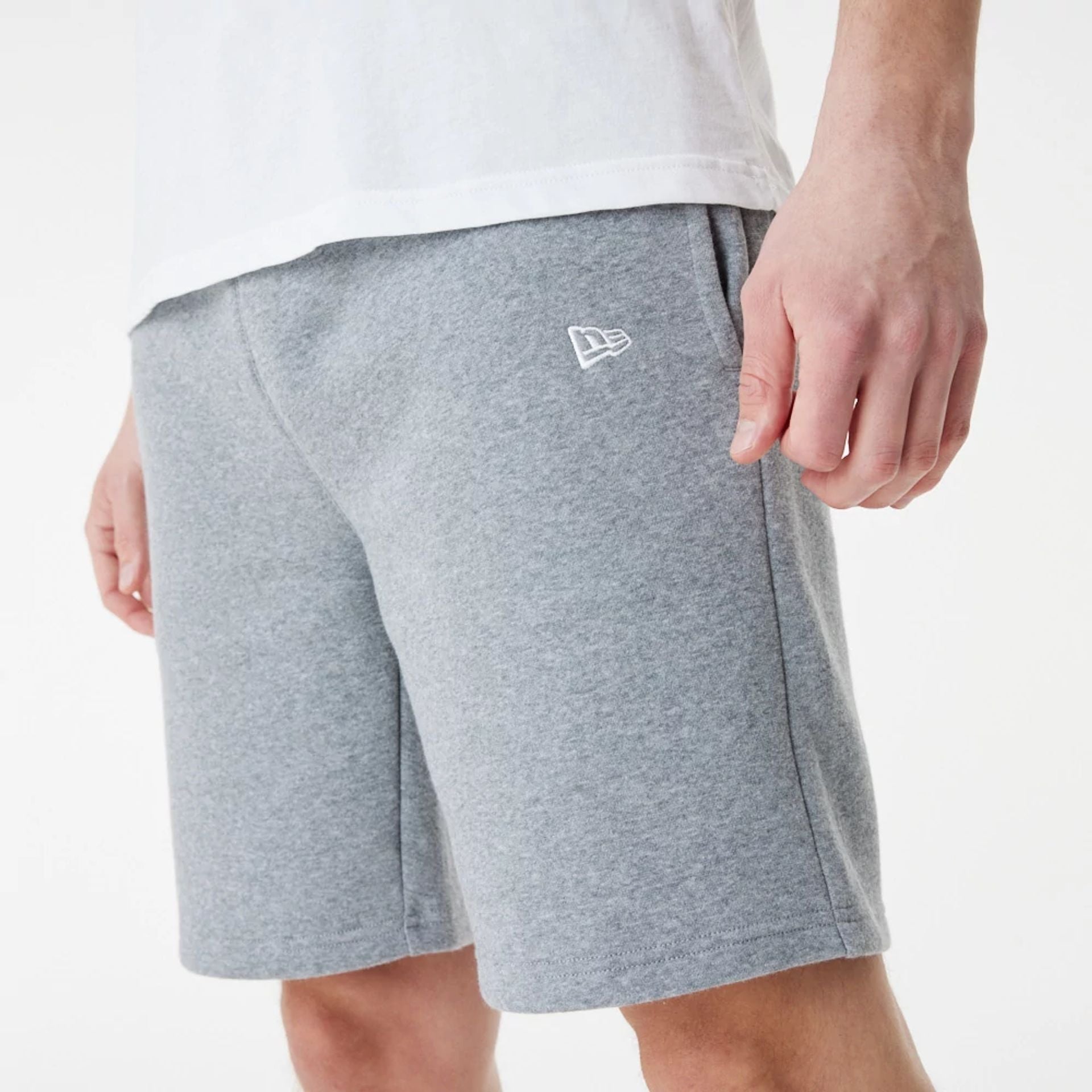 The Male model is wearing New Era Grey Essential Shorts 1