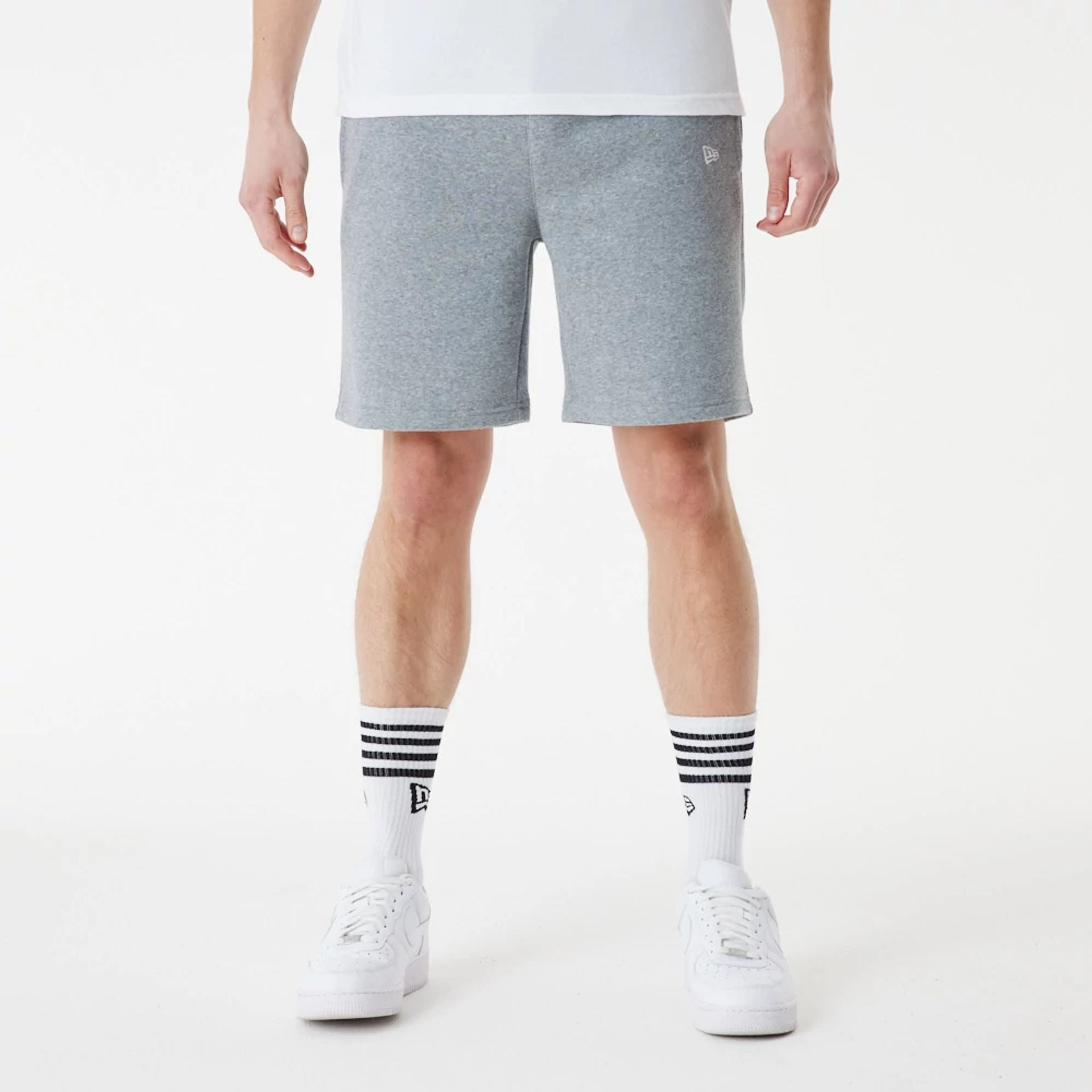 The Male model is wearing New Era Grey Essential Shorts 3