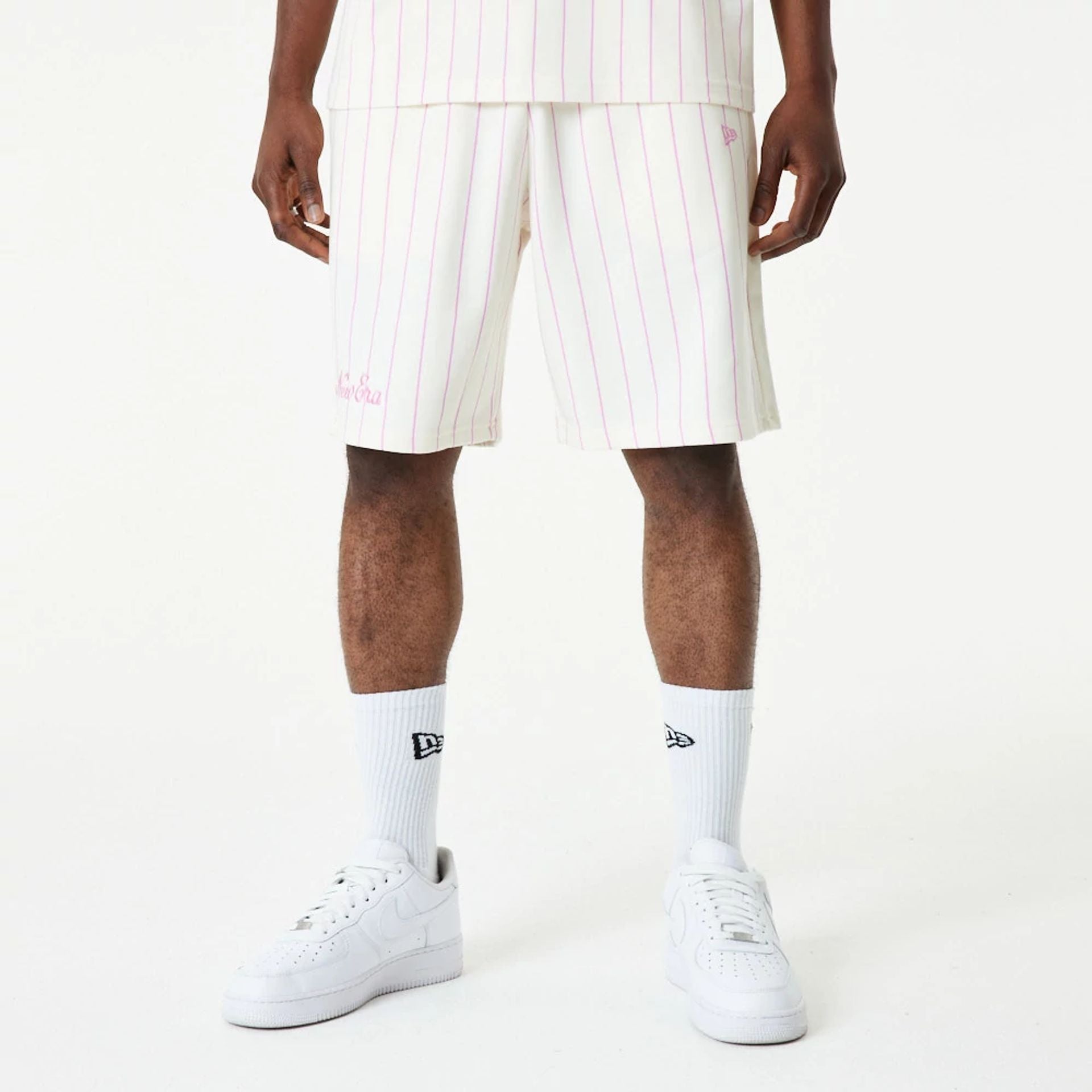 The Male model is wearing New Era Pink Pinstripe White Shorts 5