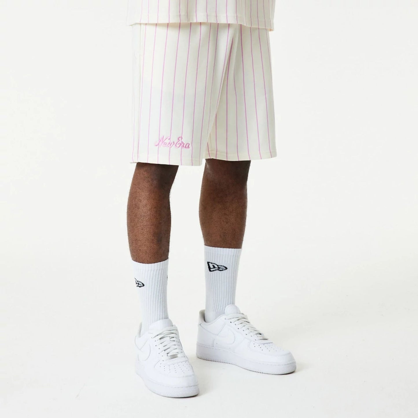 The Male model is wearing New Era Pink Pinstripe White Shorts 7