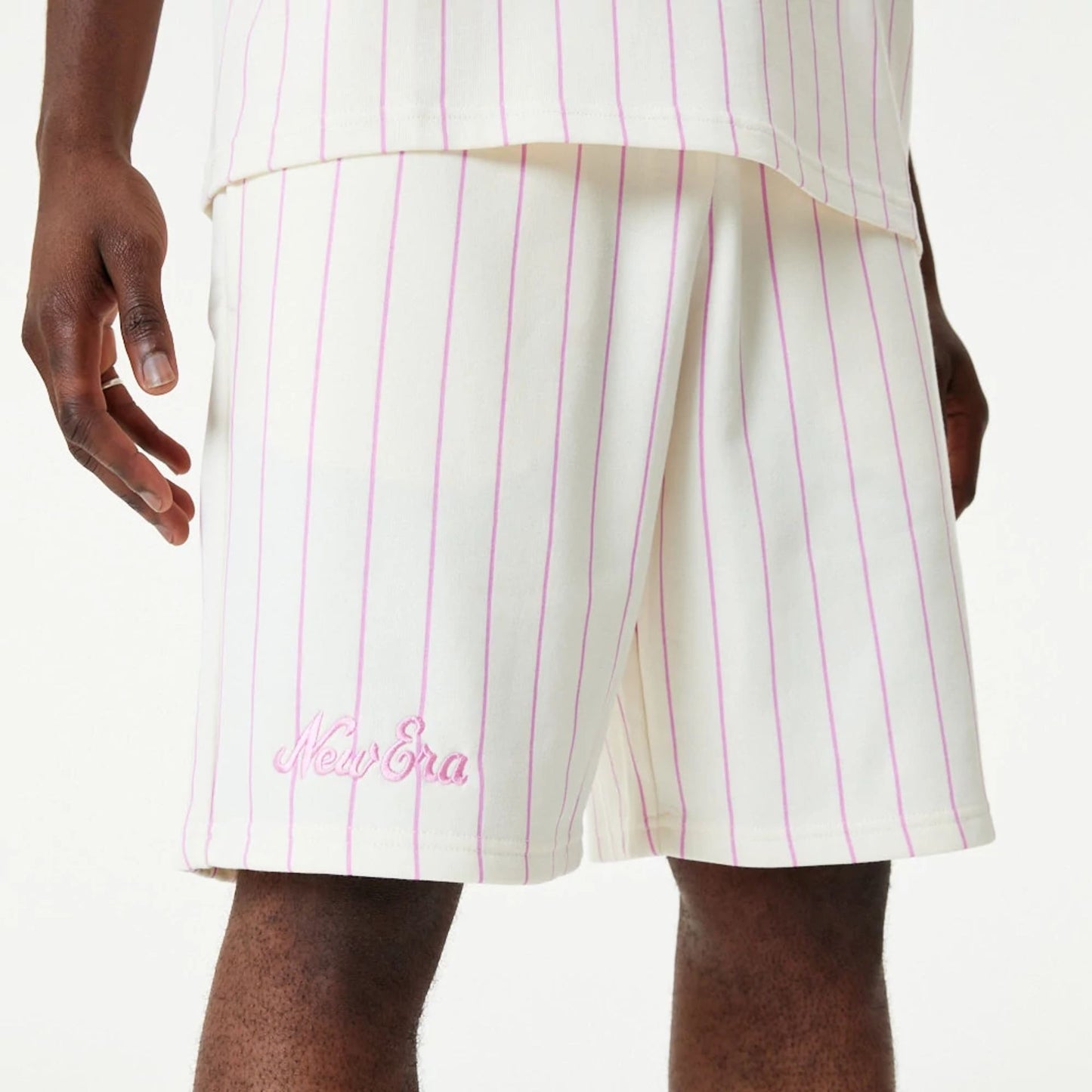 The Male model is wearing New Era Pink Pinstripe White Shorts 1