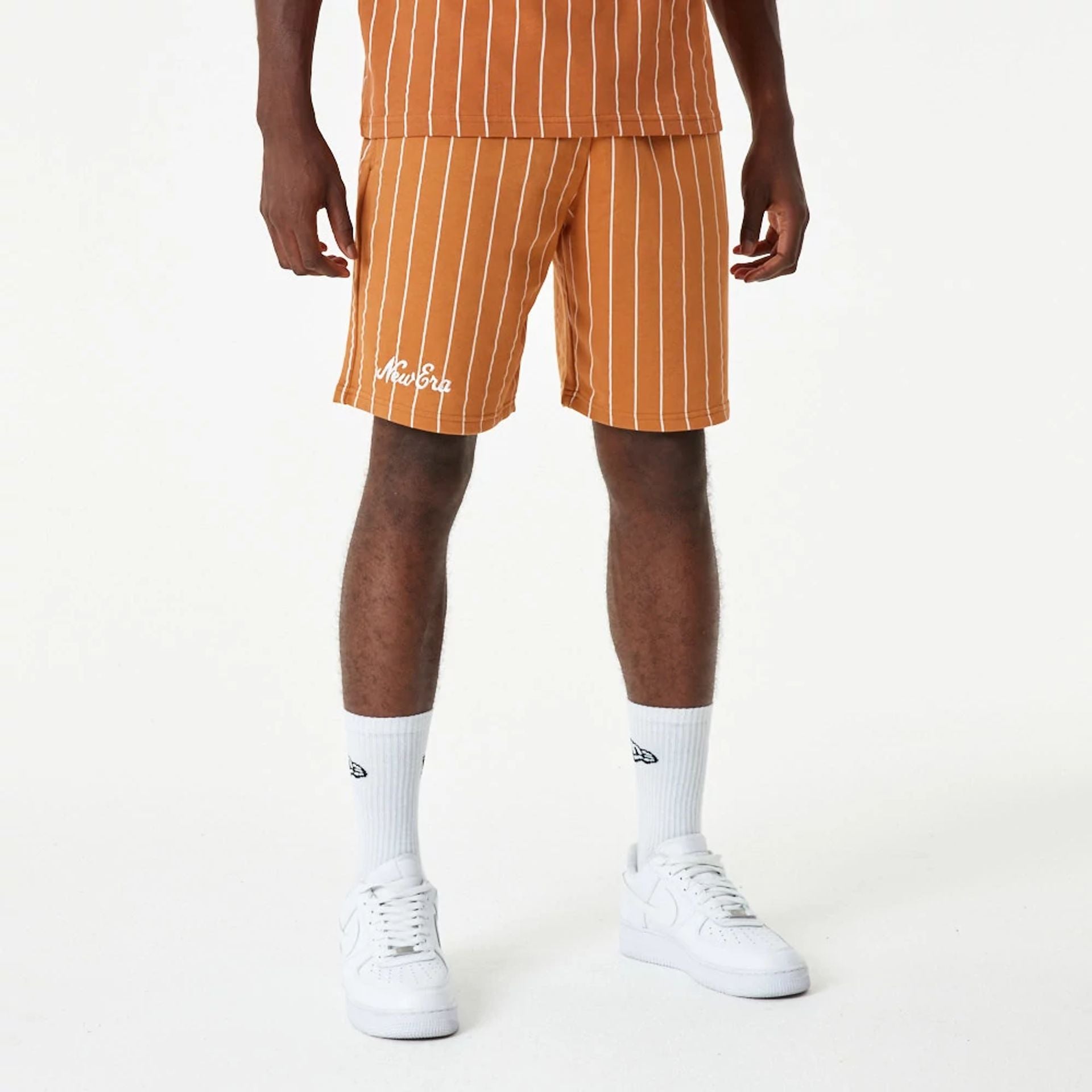 The Male model is wearing New Era Pinstripe Orange Shorts 2