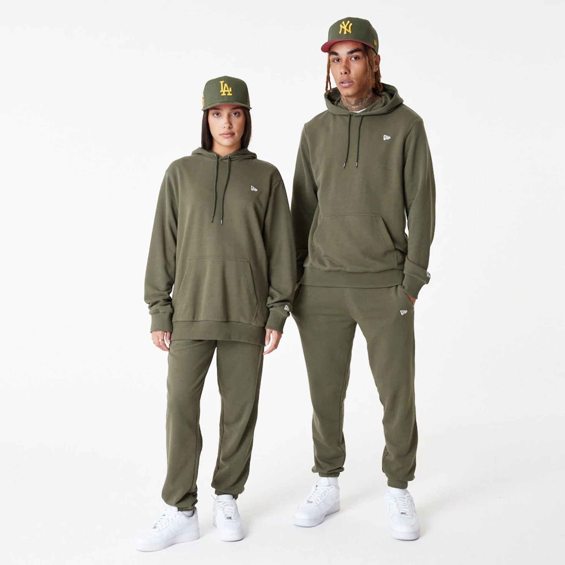 The Male model is wearing New Era Essential Green Pullover Hoodie 1