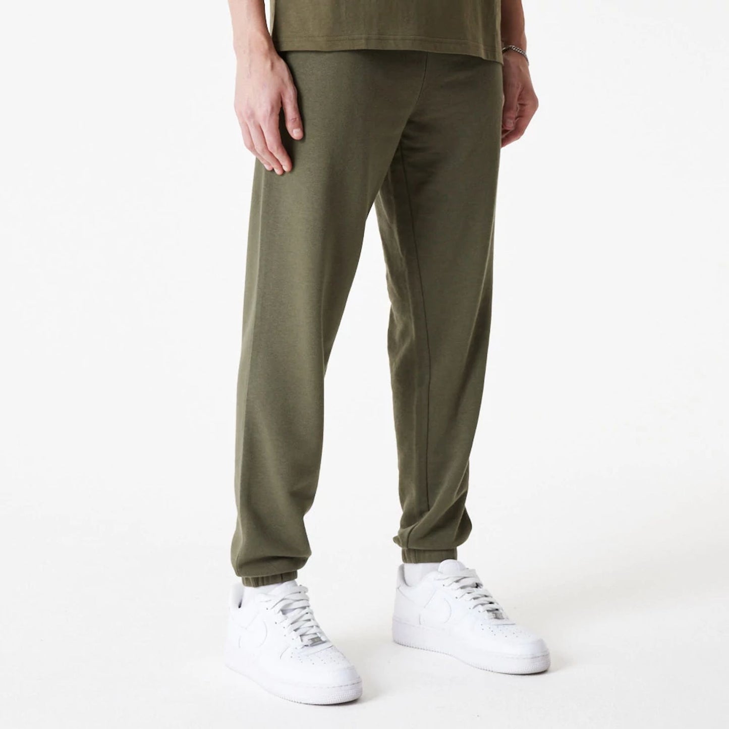 The Male model is wearing New Era Essential Green Joggers 6