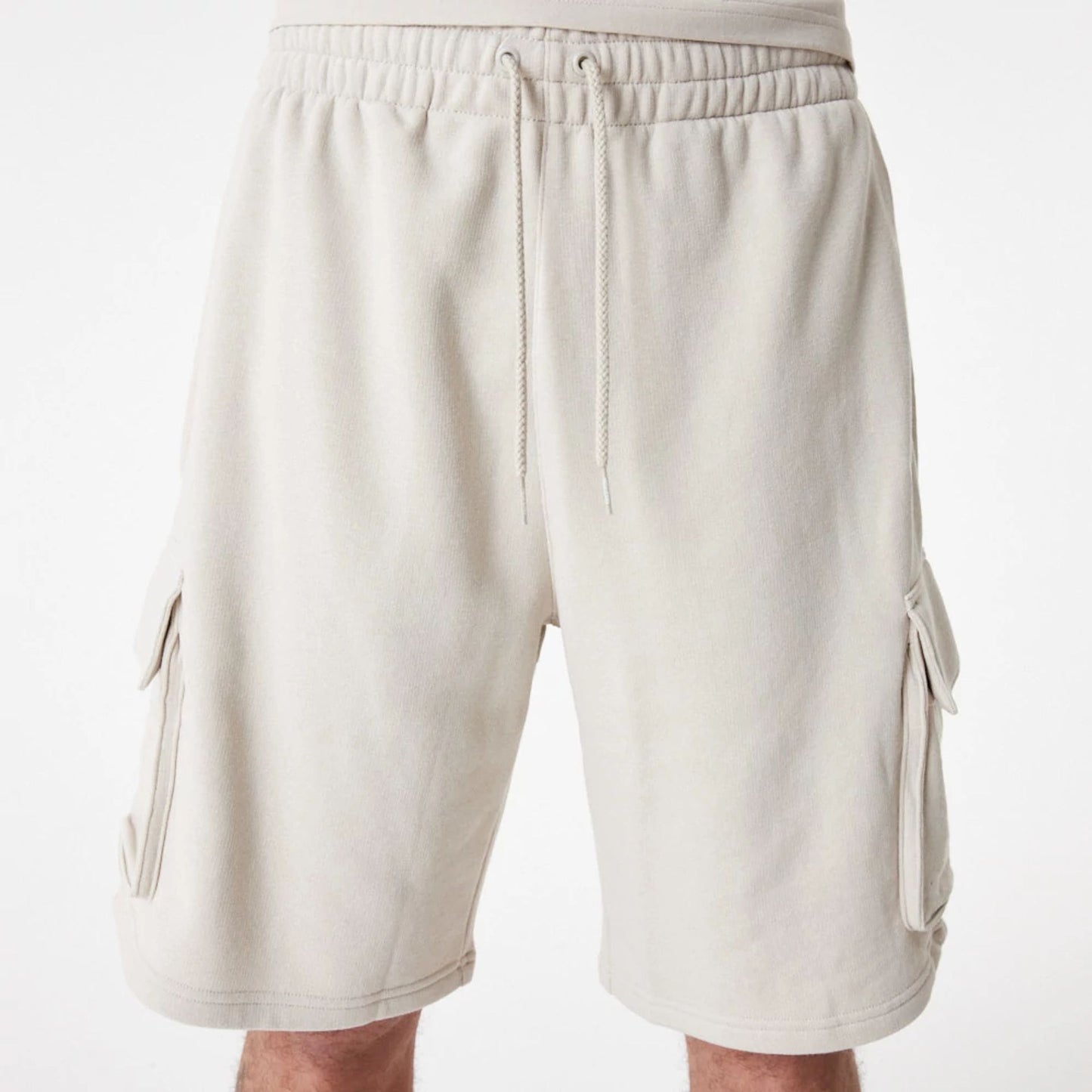 The Male model is wearing New Era Essential Stone Shorts 4