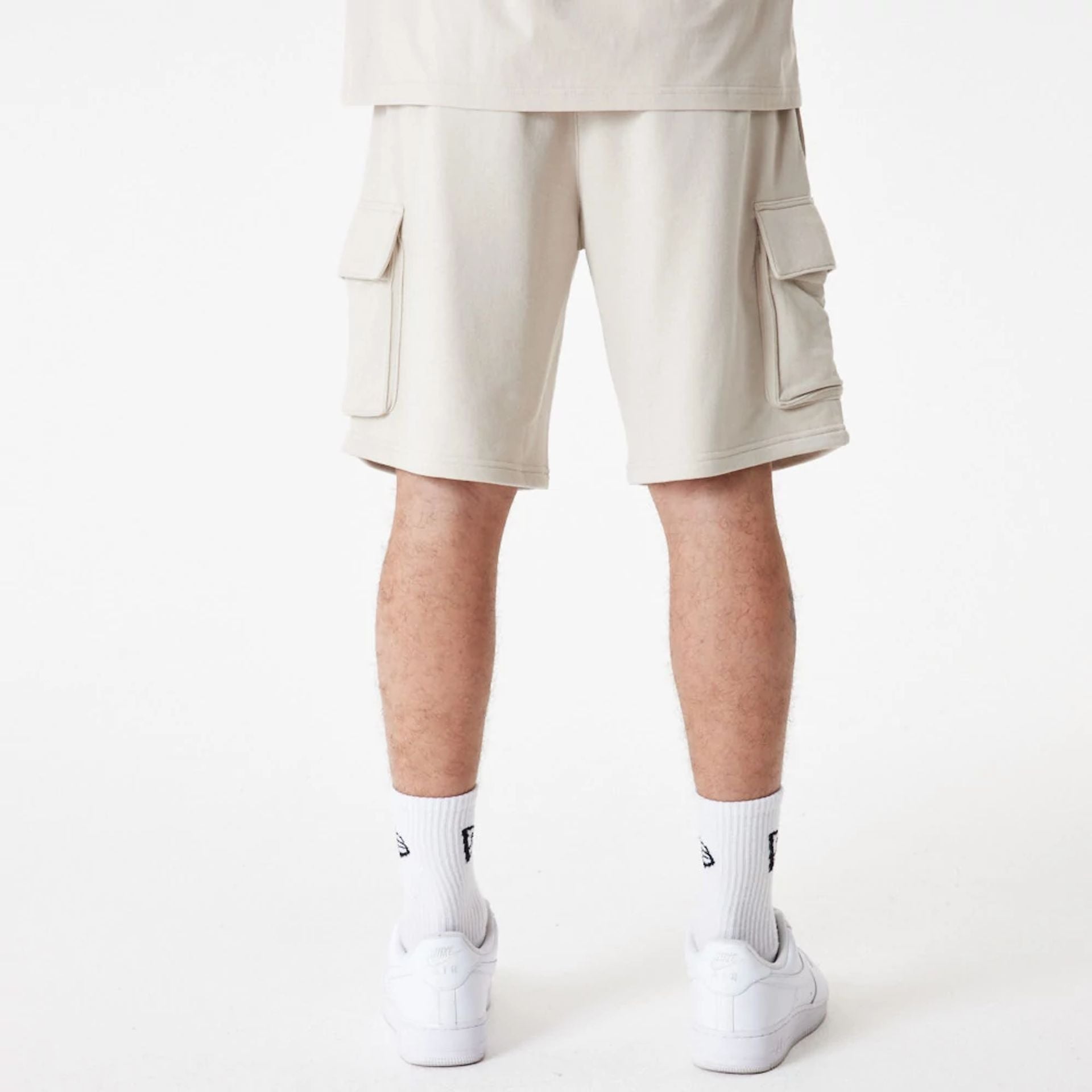 The Male model is wearing New Era Essential Stone Shorts 5