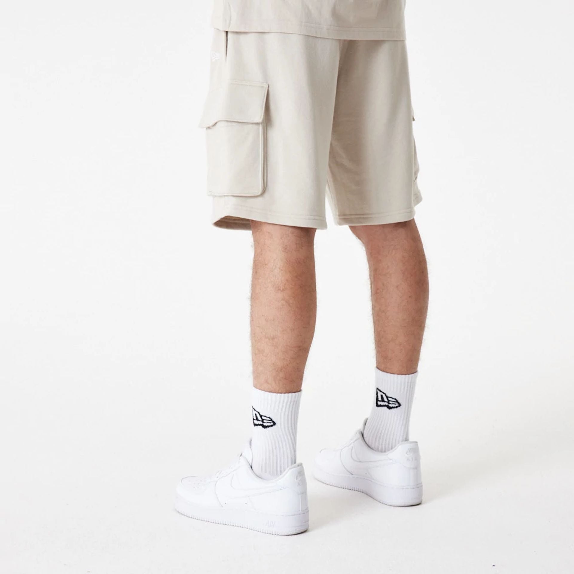 The Male model is wearing New Era Essential Stone Shorts 7