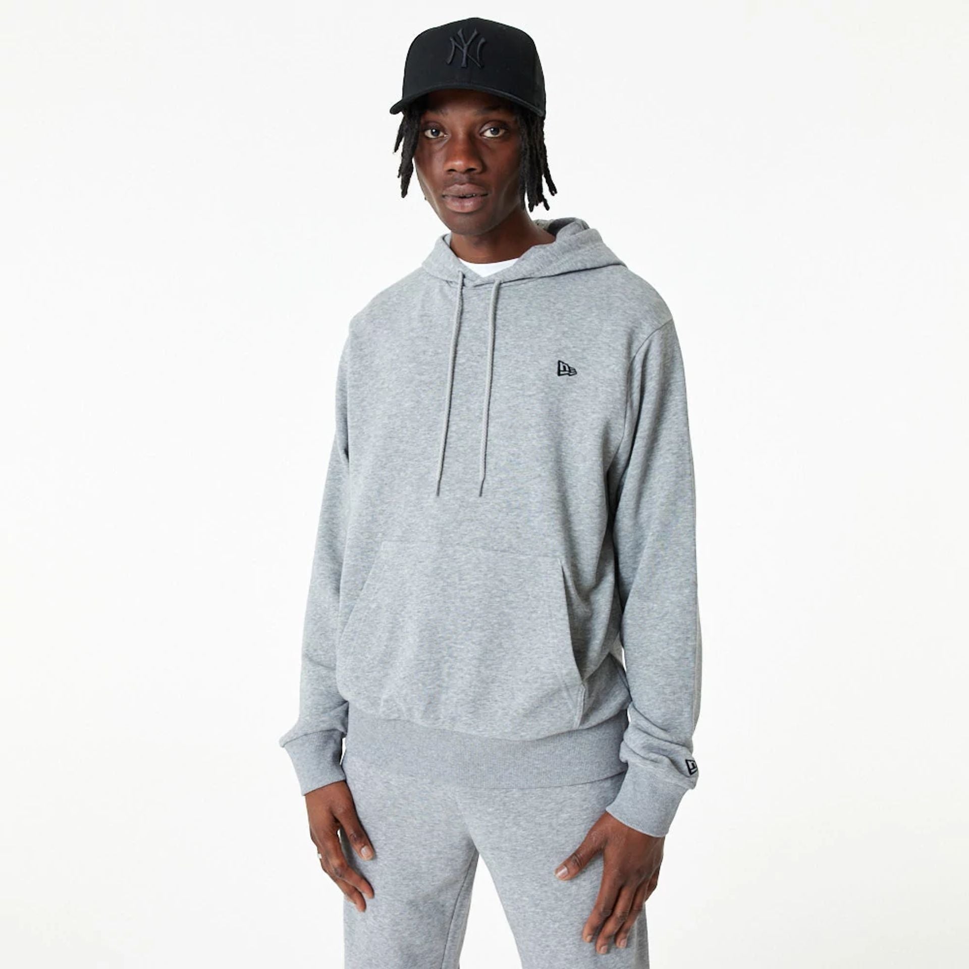 The Male model is wearing New Era Essential Grey Pullover Hoodie 2